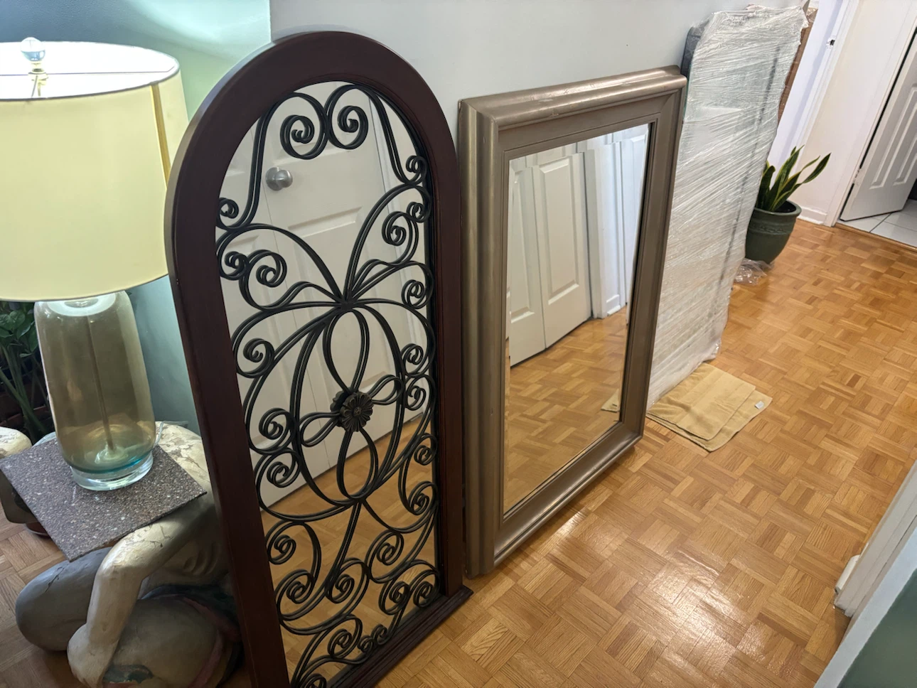Arched wall mirror with metal scrollwork