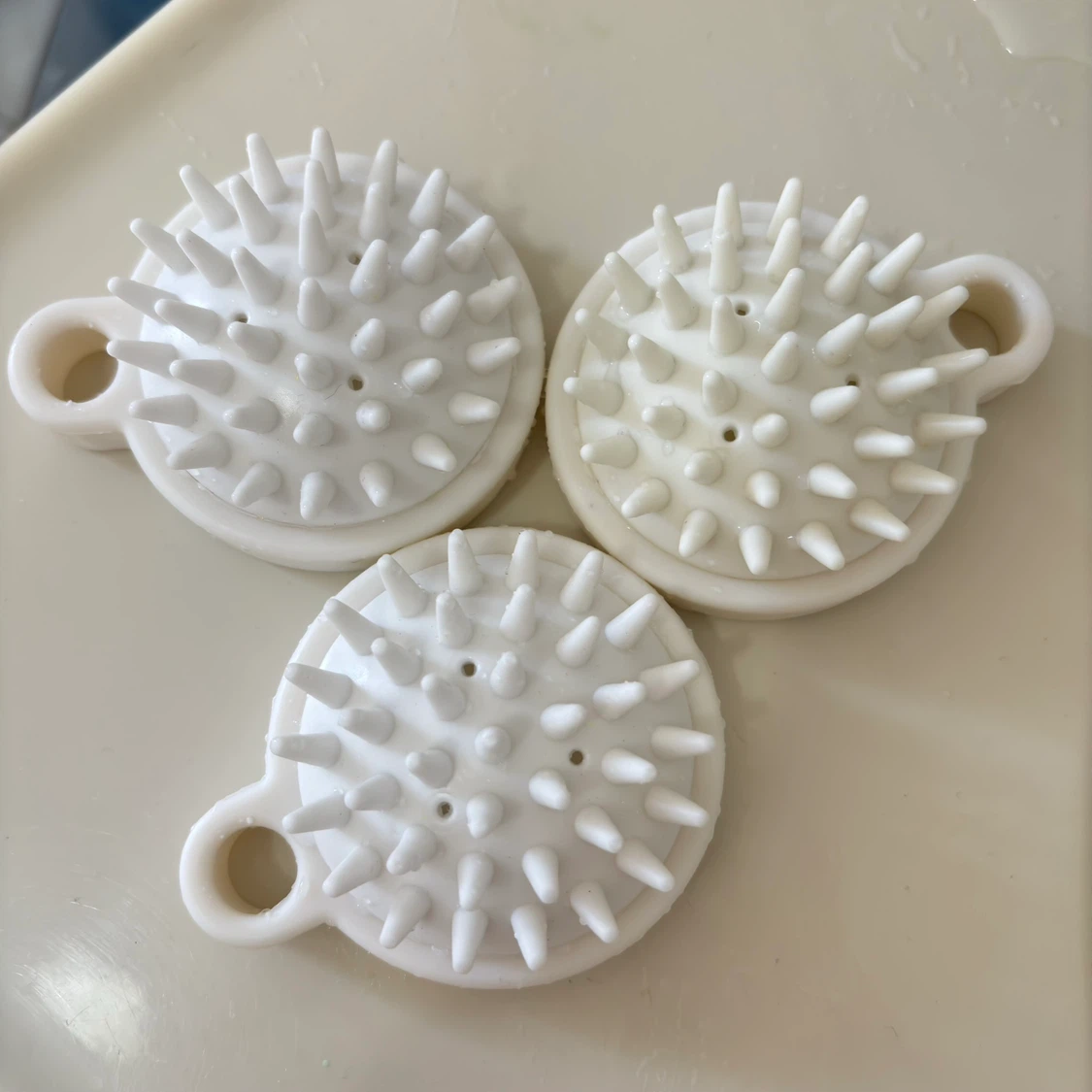 White scalp massager brushes