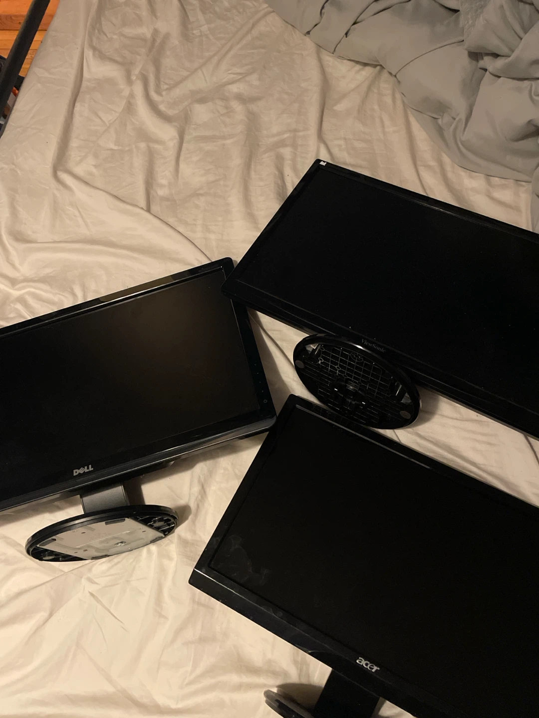 Three assorted desktop computer monitors