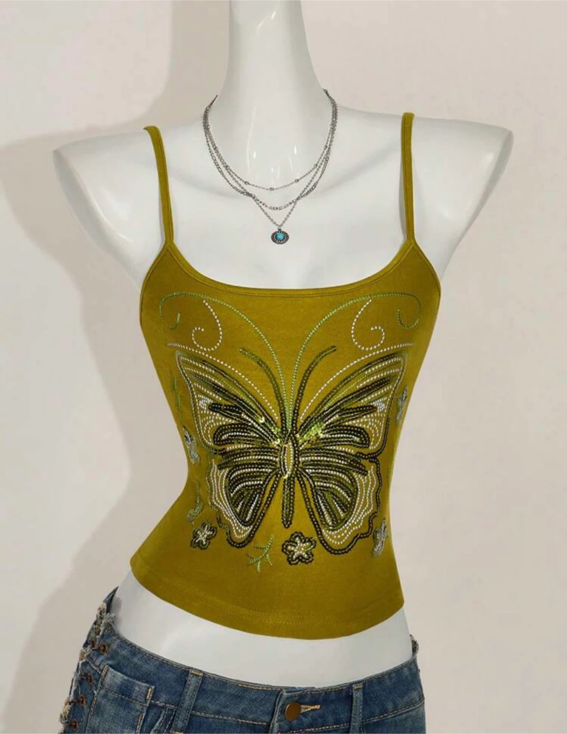 green embroidered top