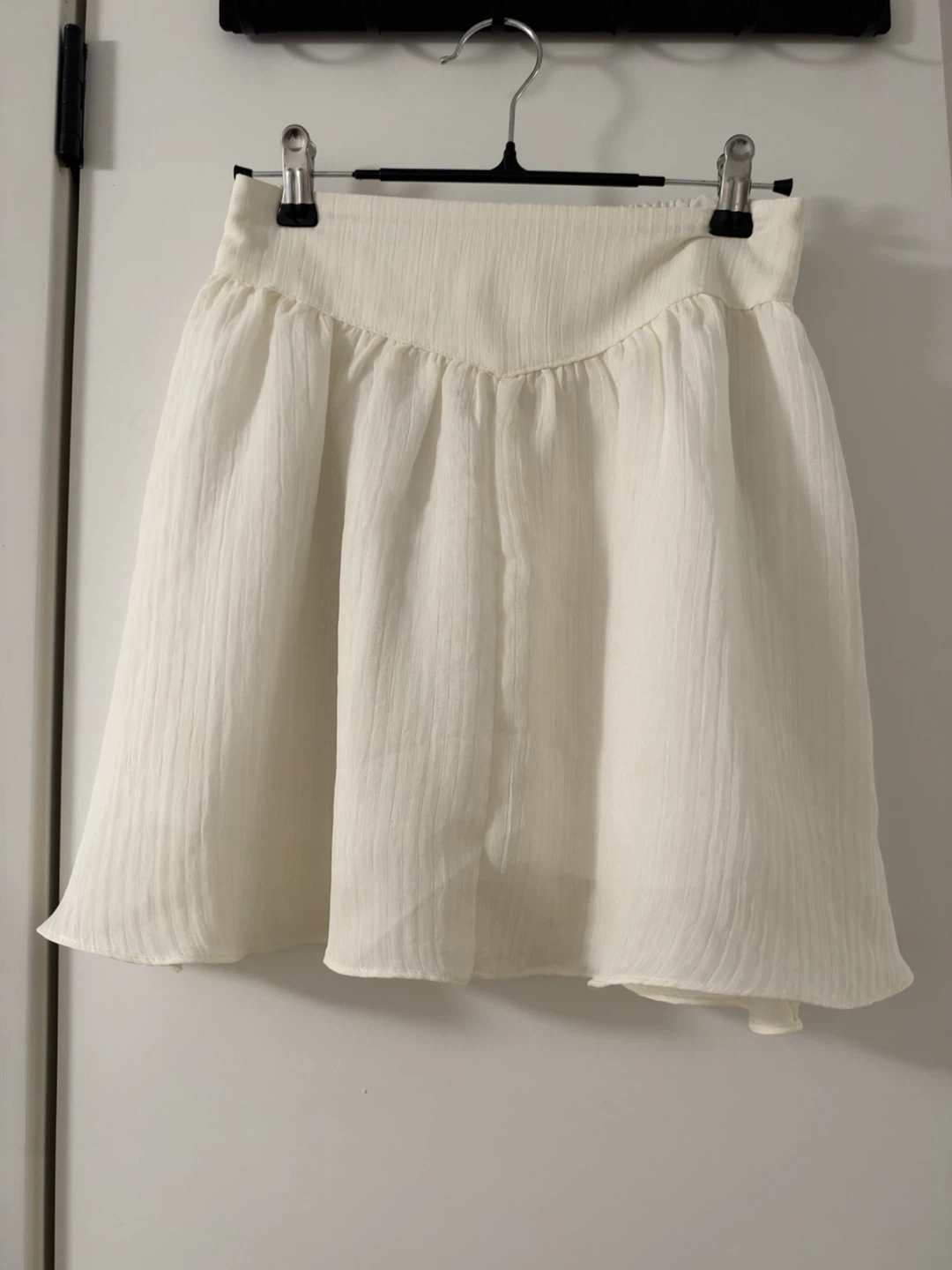 White pleated mini skirt