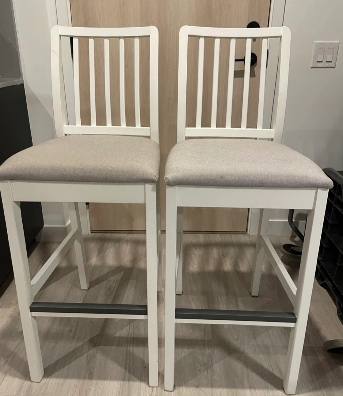 Set of two white bar stools with grey seat cushions