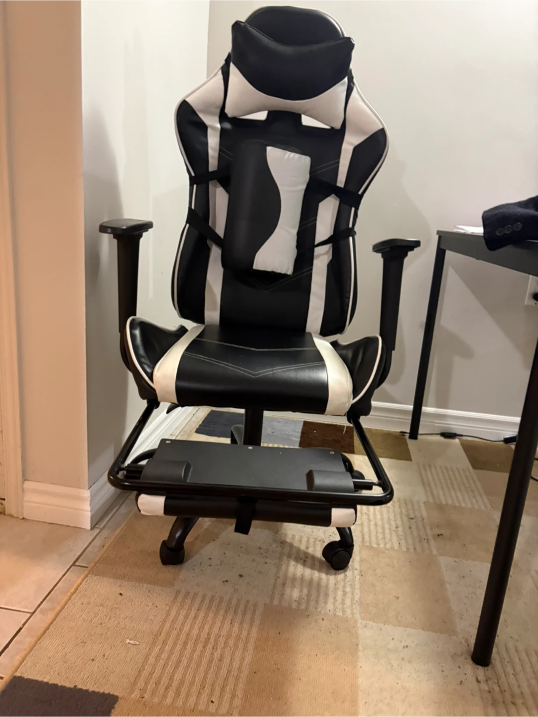 Black and white gaming chair with footrest