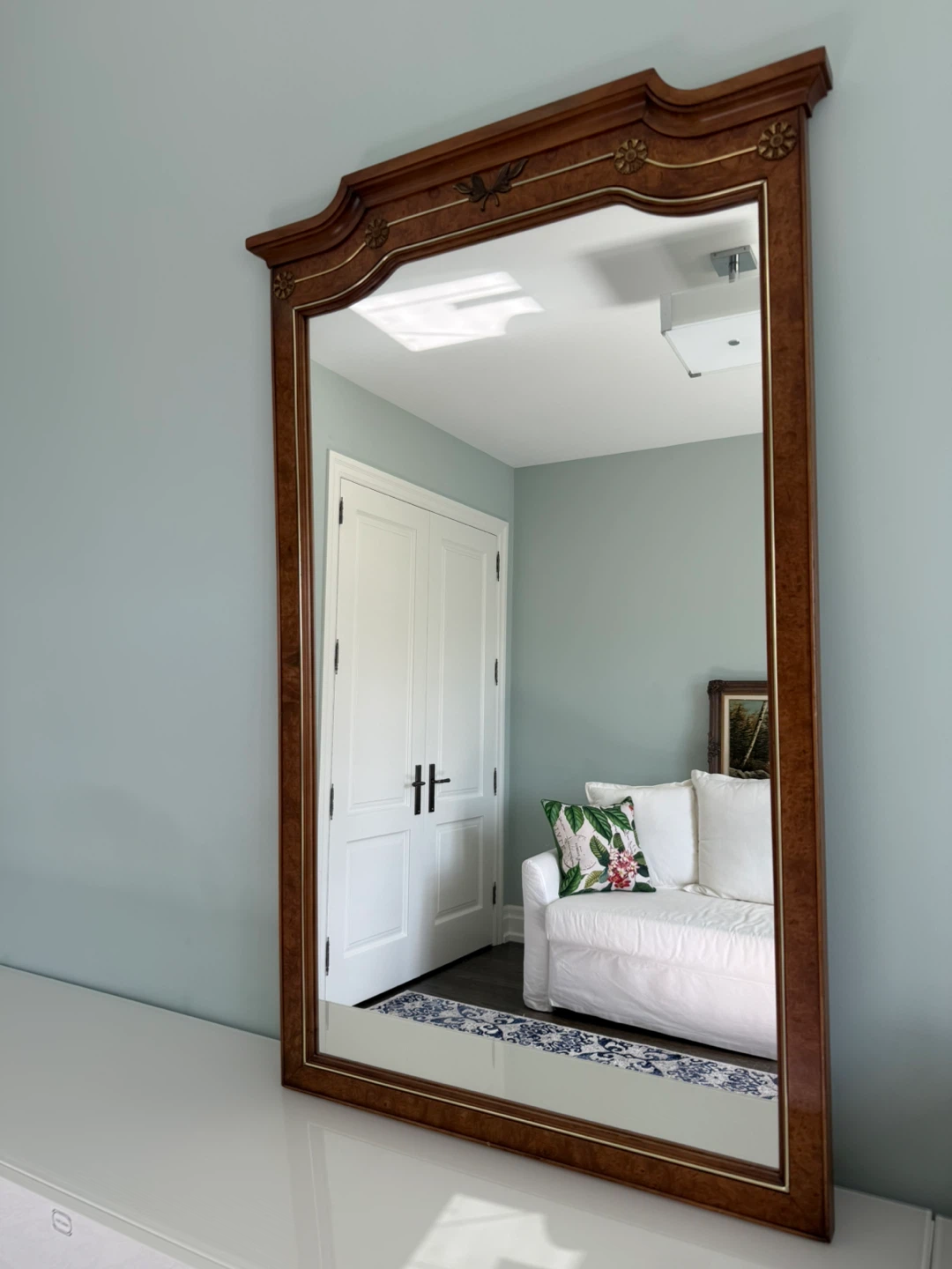 Gorgeous antique walnut burl wood mirror with carved details.