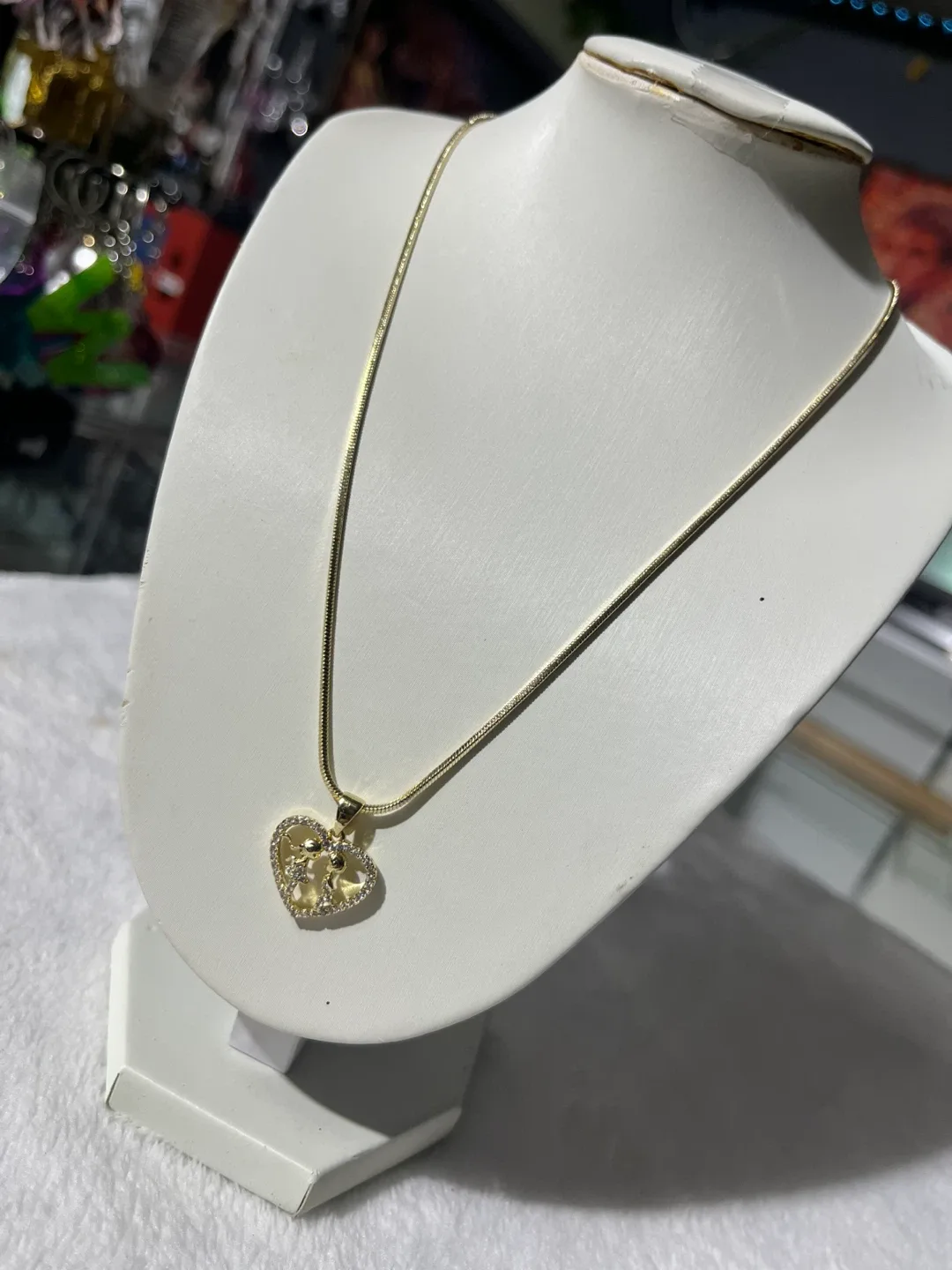 Gold-tone heart and Chanel-style logo pendant necklace