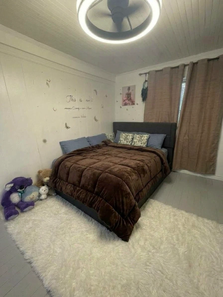 Black upholstered bed frame with mattress