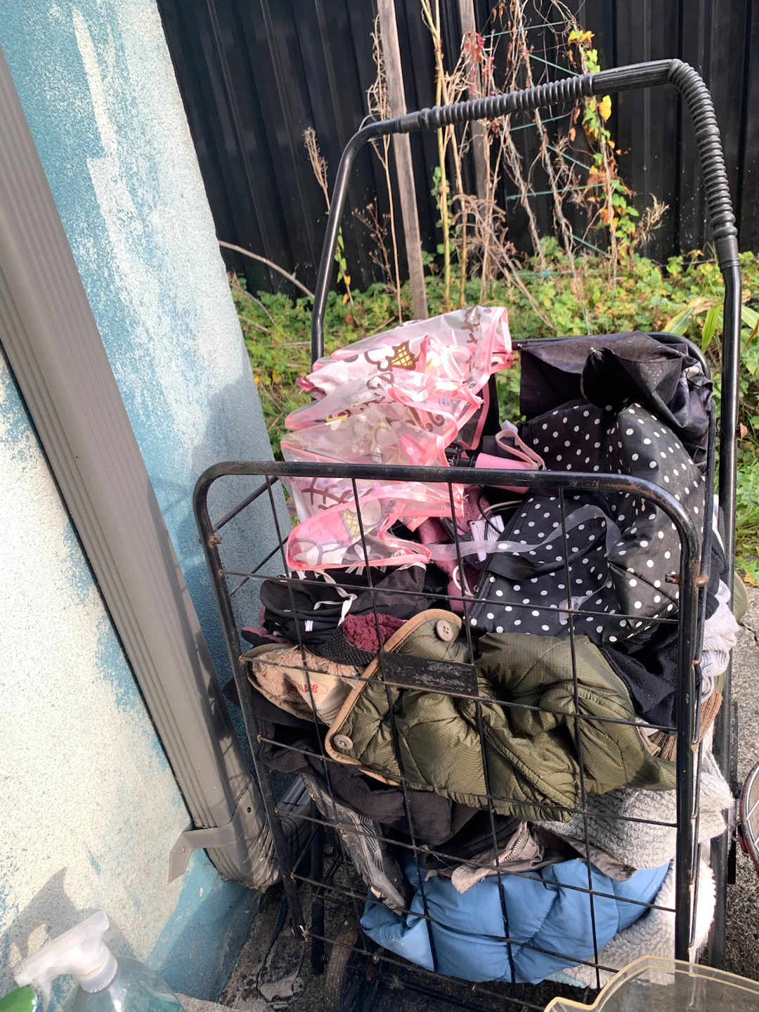 Metal Utility Shopping Cart with assorted woman clothes, etc.