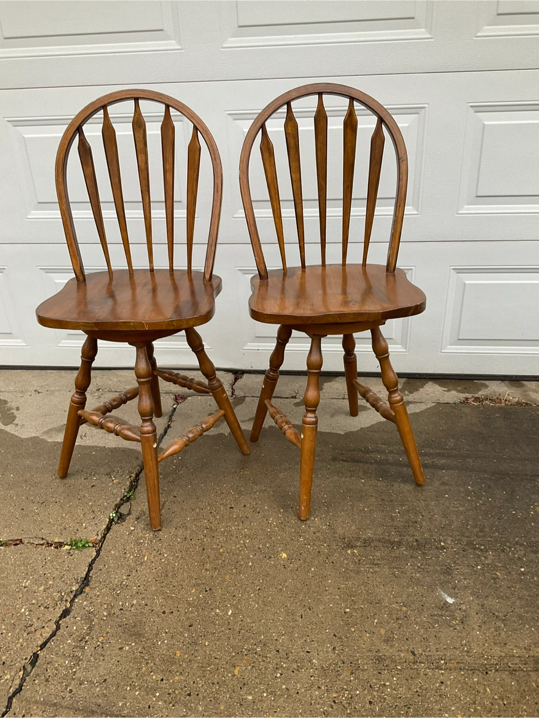 Two wooden swivel bar stools