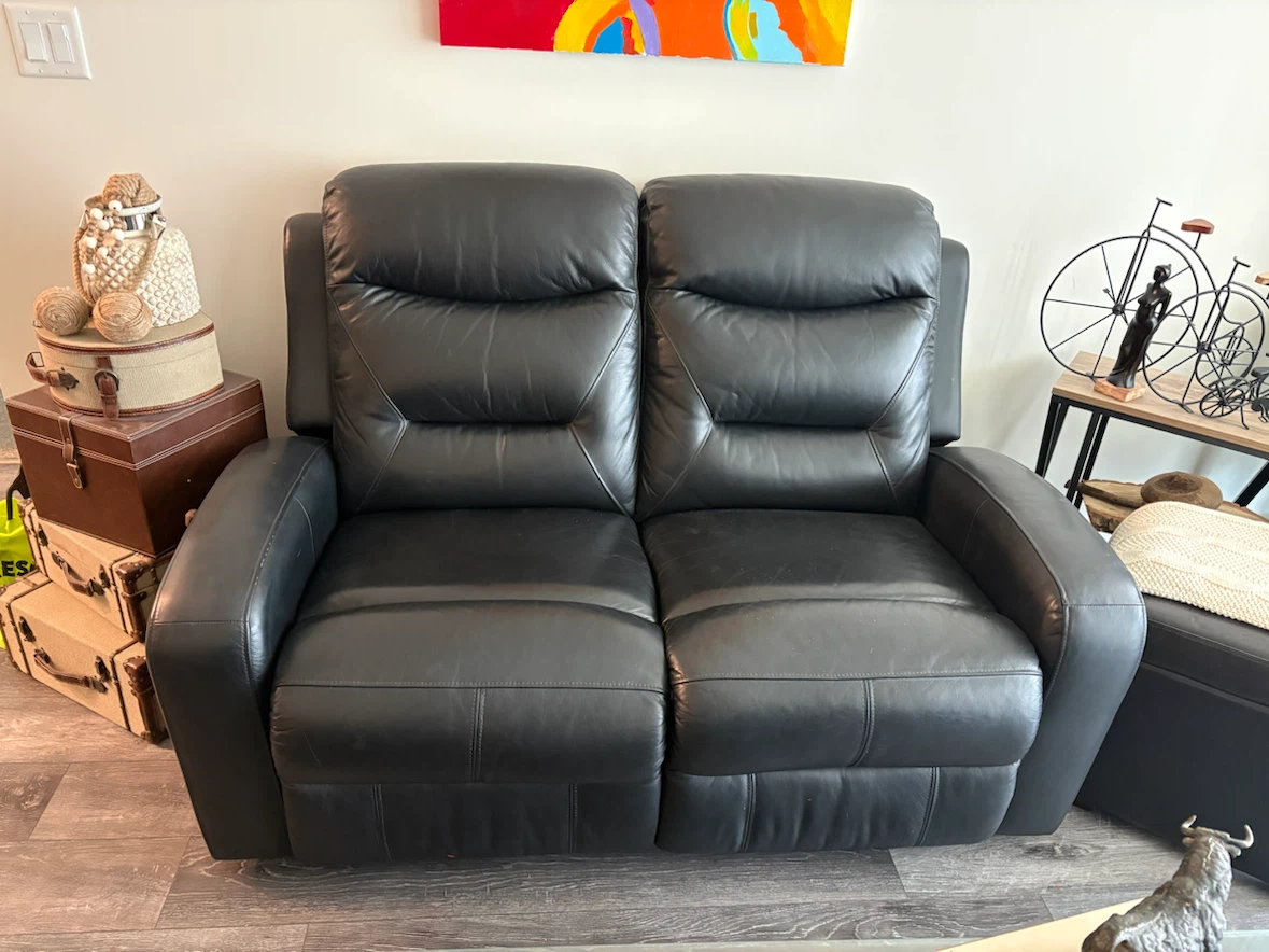 Black leather reclining loveseat