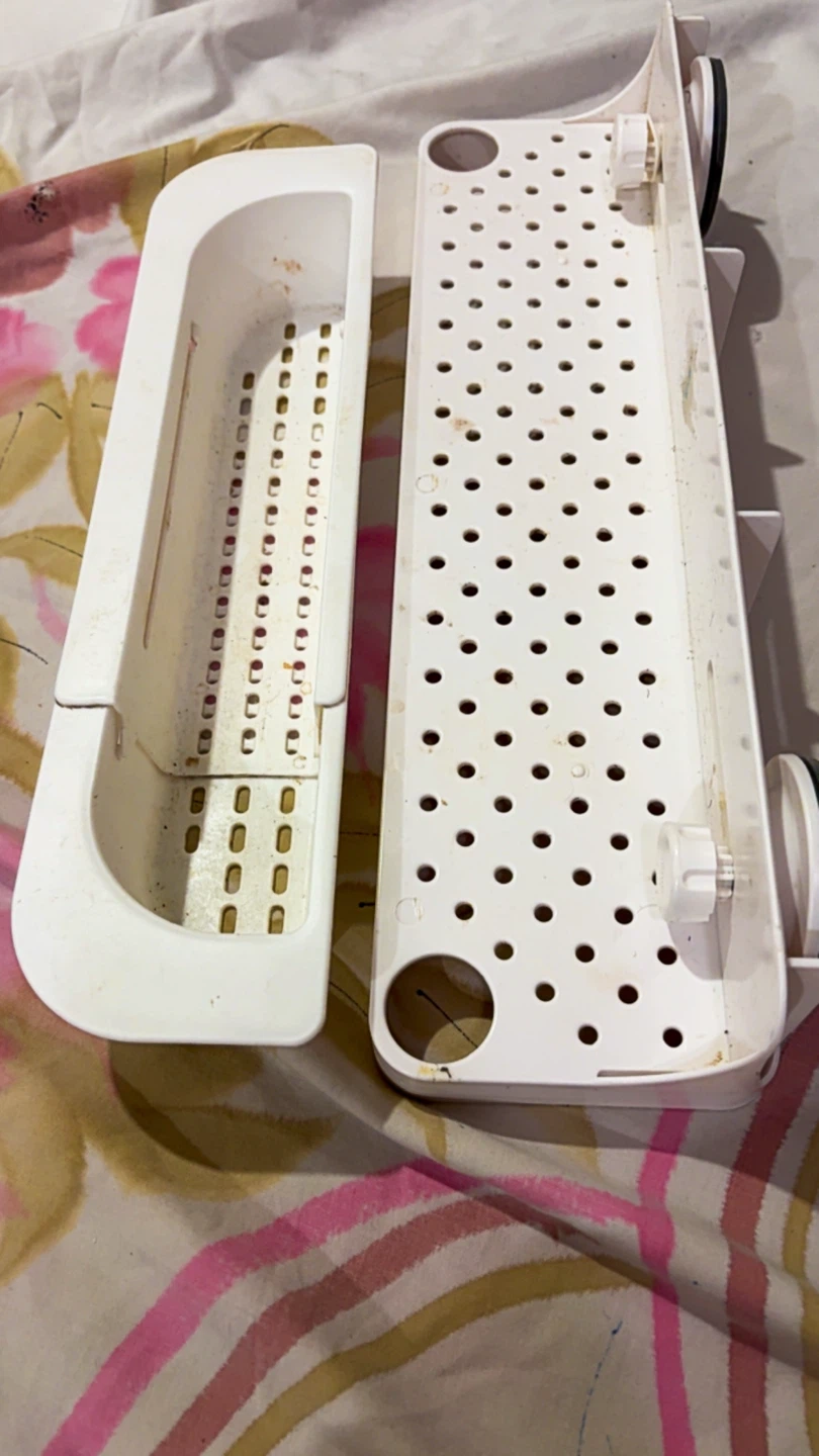 White plastic suction cup shower shelf
