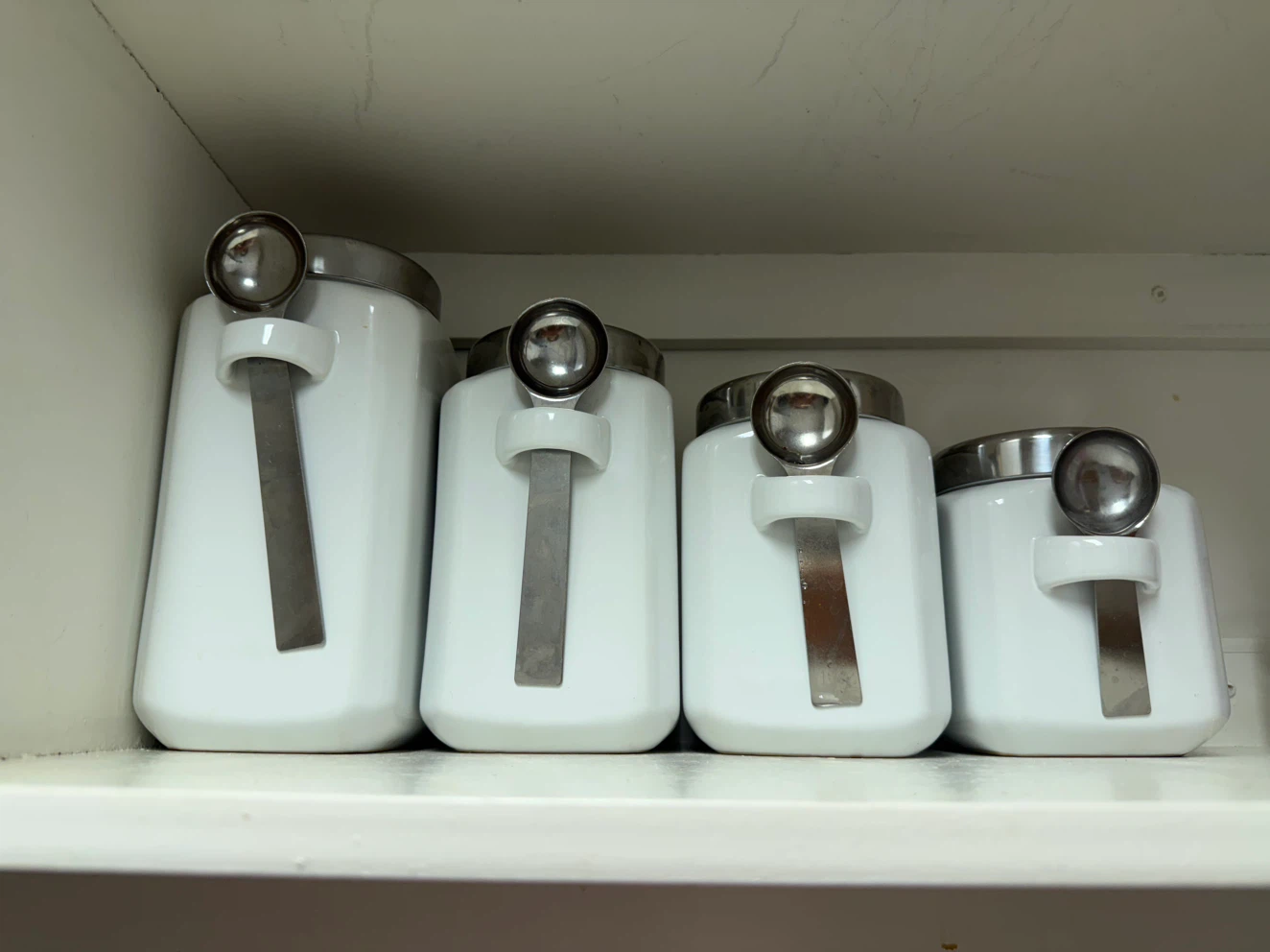 Set of 4 White Ceramic Canisters with Measuring Spoons