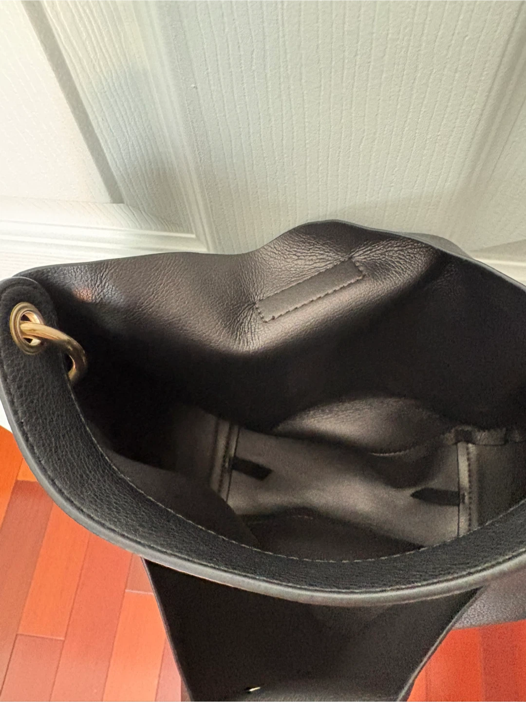 Black bucket bag with gold chain strap