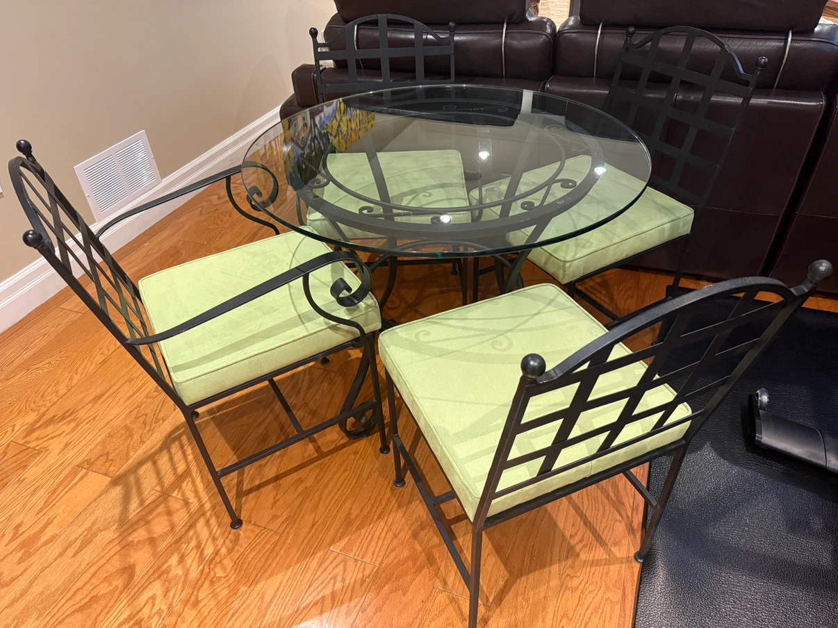 Wrought iron dining set with glass top table and 4 chairs