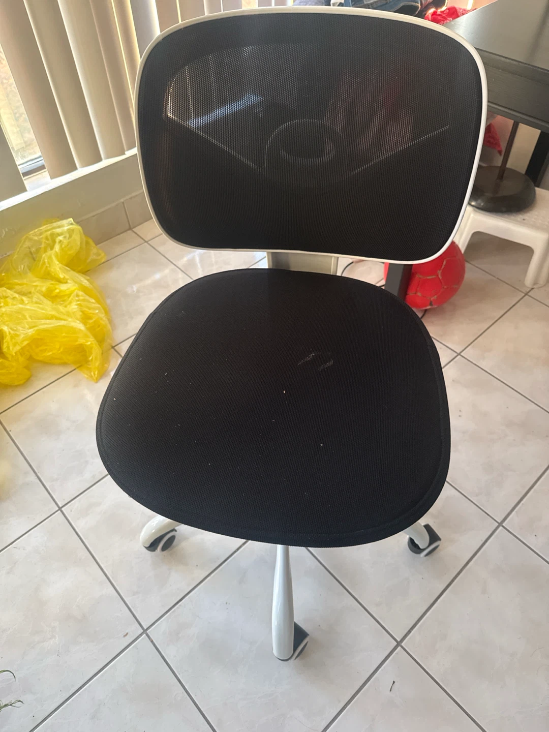 Black mesh office chair and table