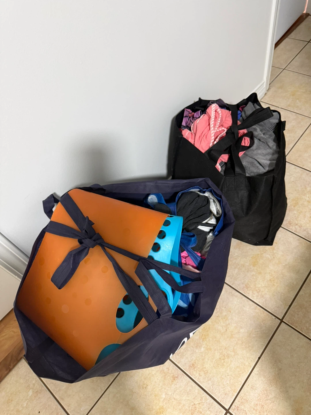 Assorted children's clothing in reusable bags