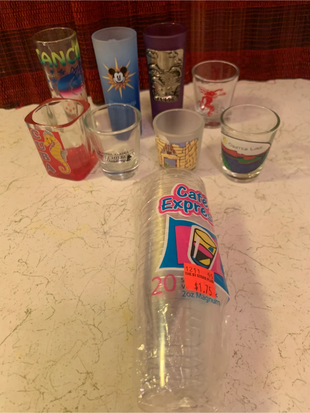 Collection of 7 Souvenir Shot Glasses and 20 Plastic Cups