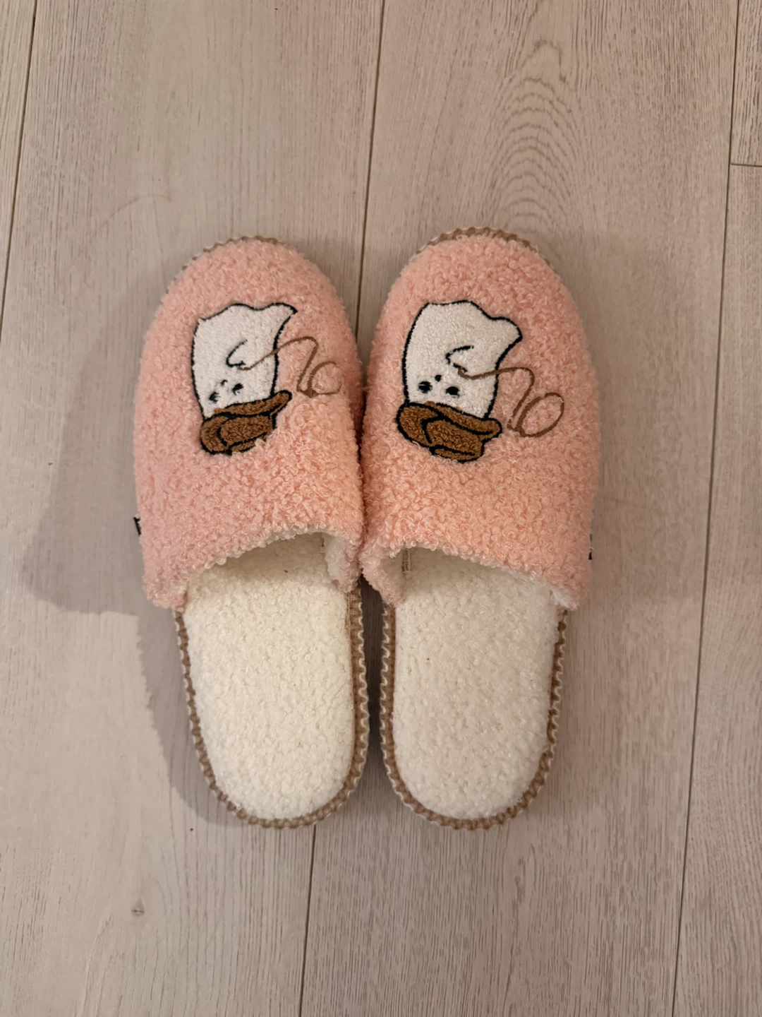Pink fuzzy slippers with cute ghost character