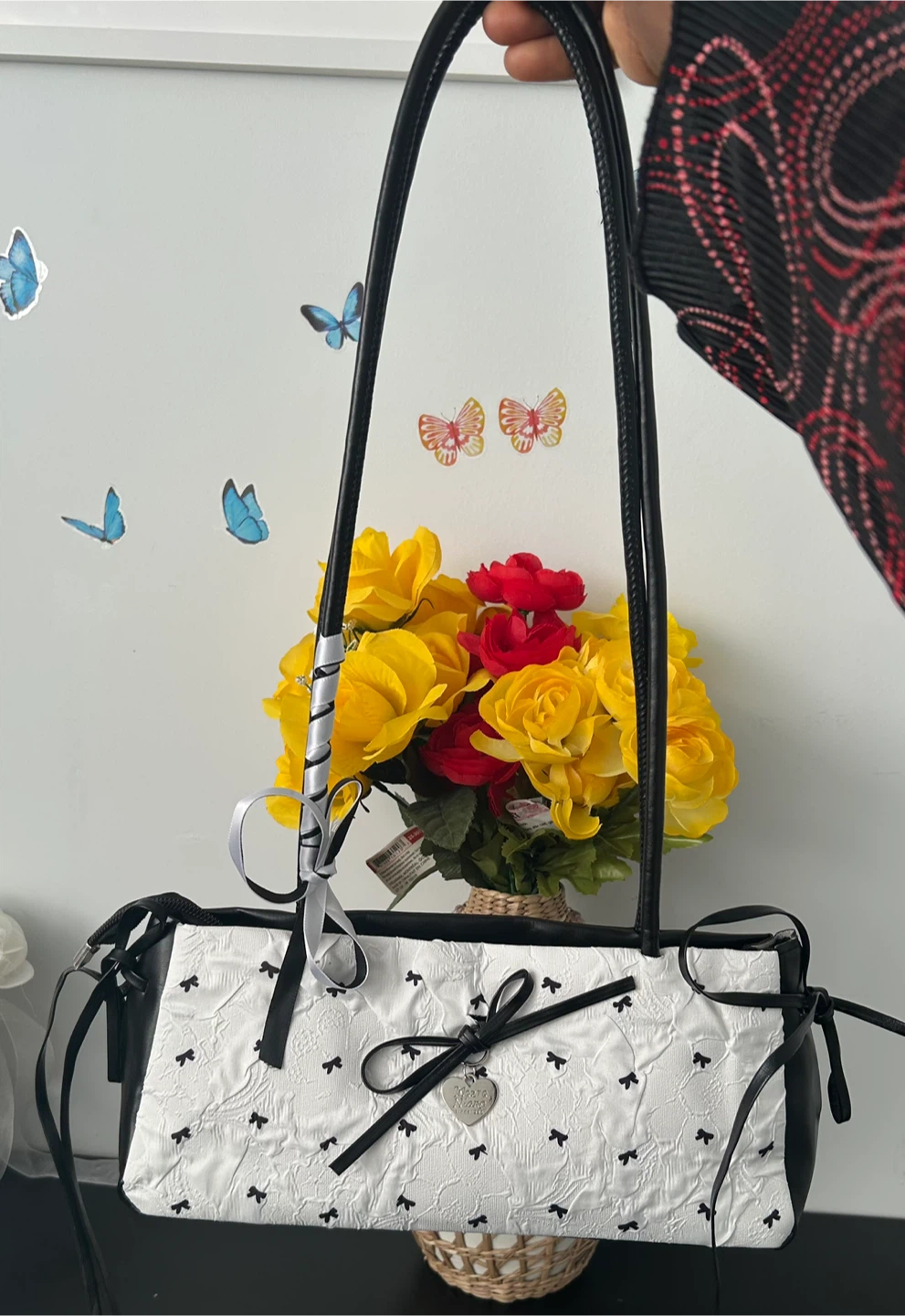 Sac à main blanc et noir avec motifs de petits nœuds