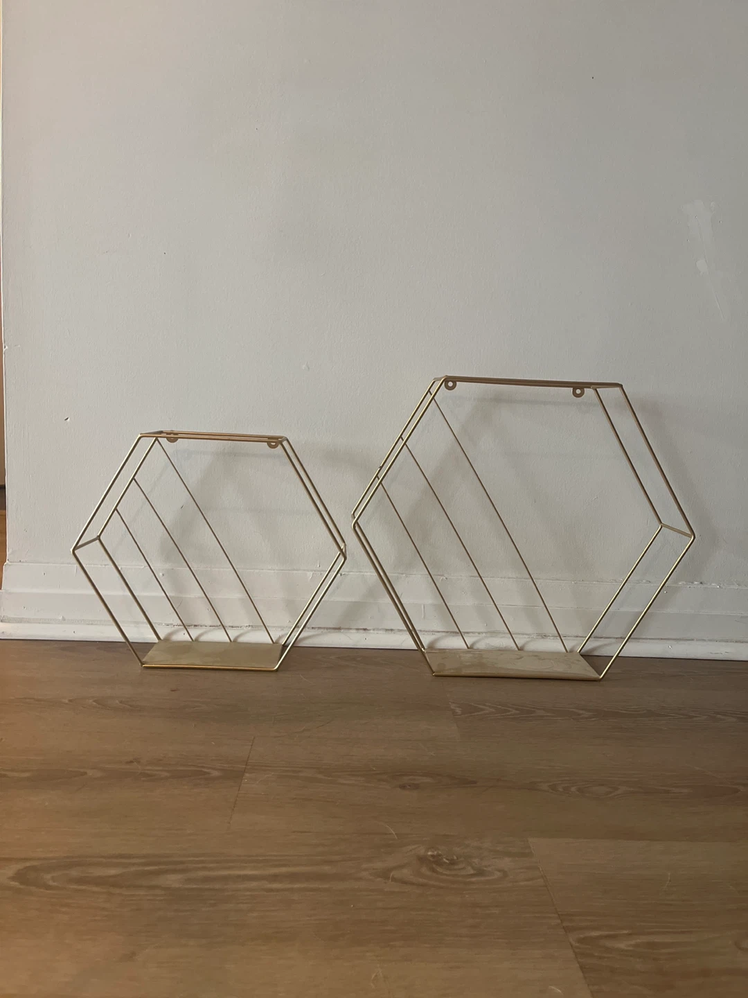 Set of two gold hexagonal wall shelves