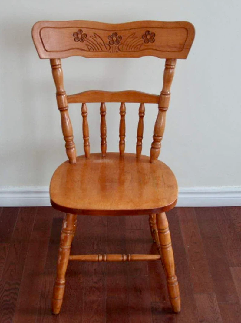 Solid wood spindle back chair with floral detail