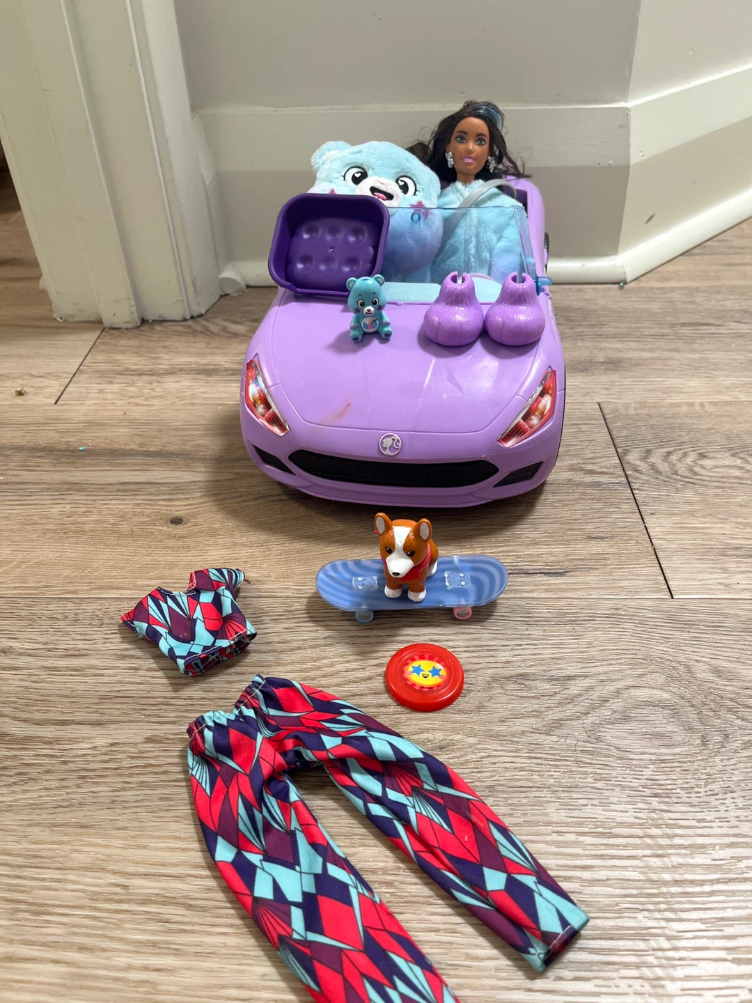 Barbie doll with purple convertible car and accessories