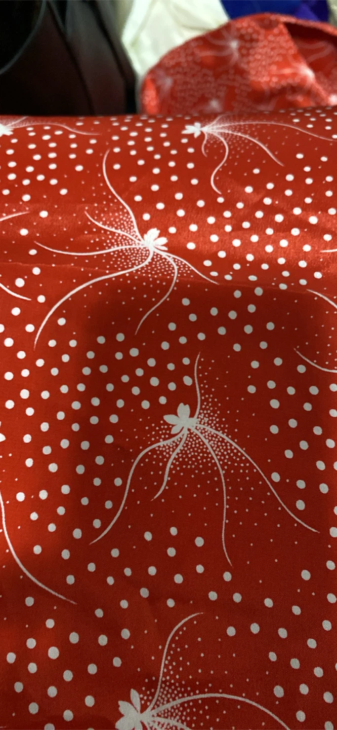 Red fabric with white floral polka dot pattern