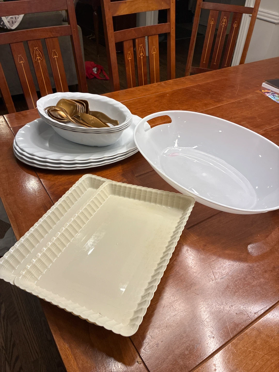 Assorted Plastic White Serving Dishes and Gold Cutlery Set