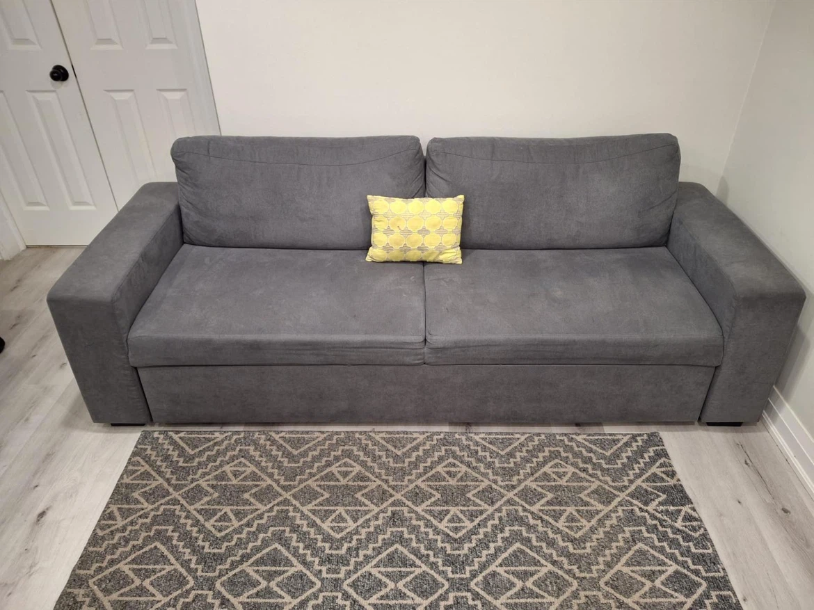 Grey sofa bed with pull-out trundle