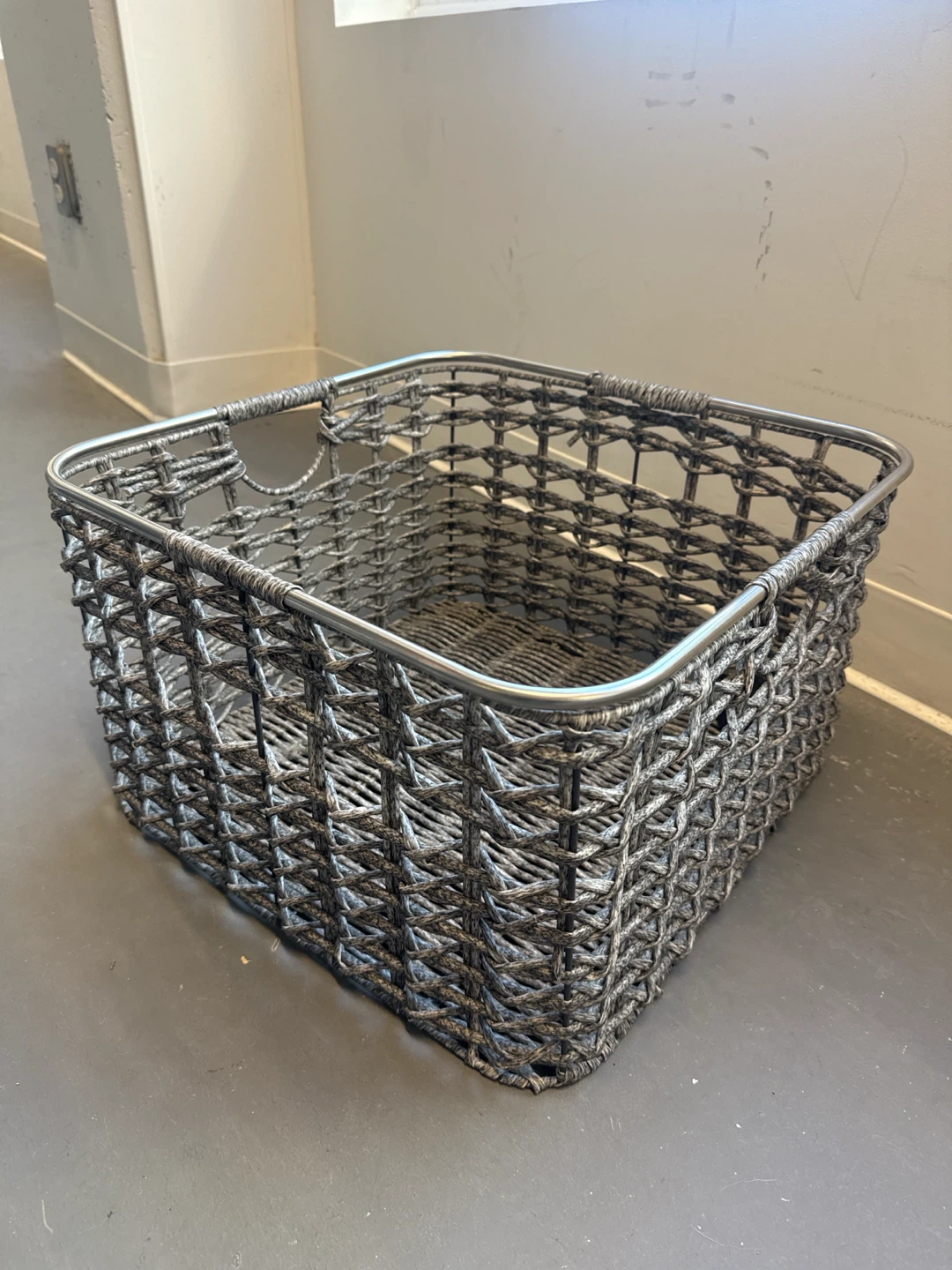 Woven storage basket with metal frame