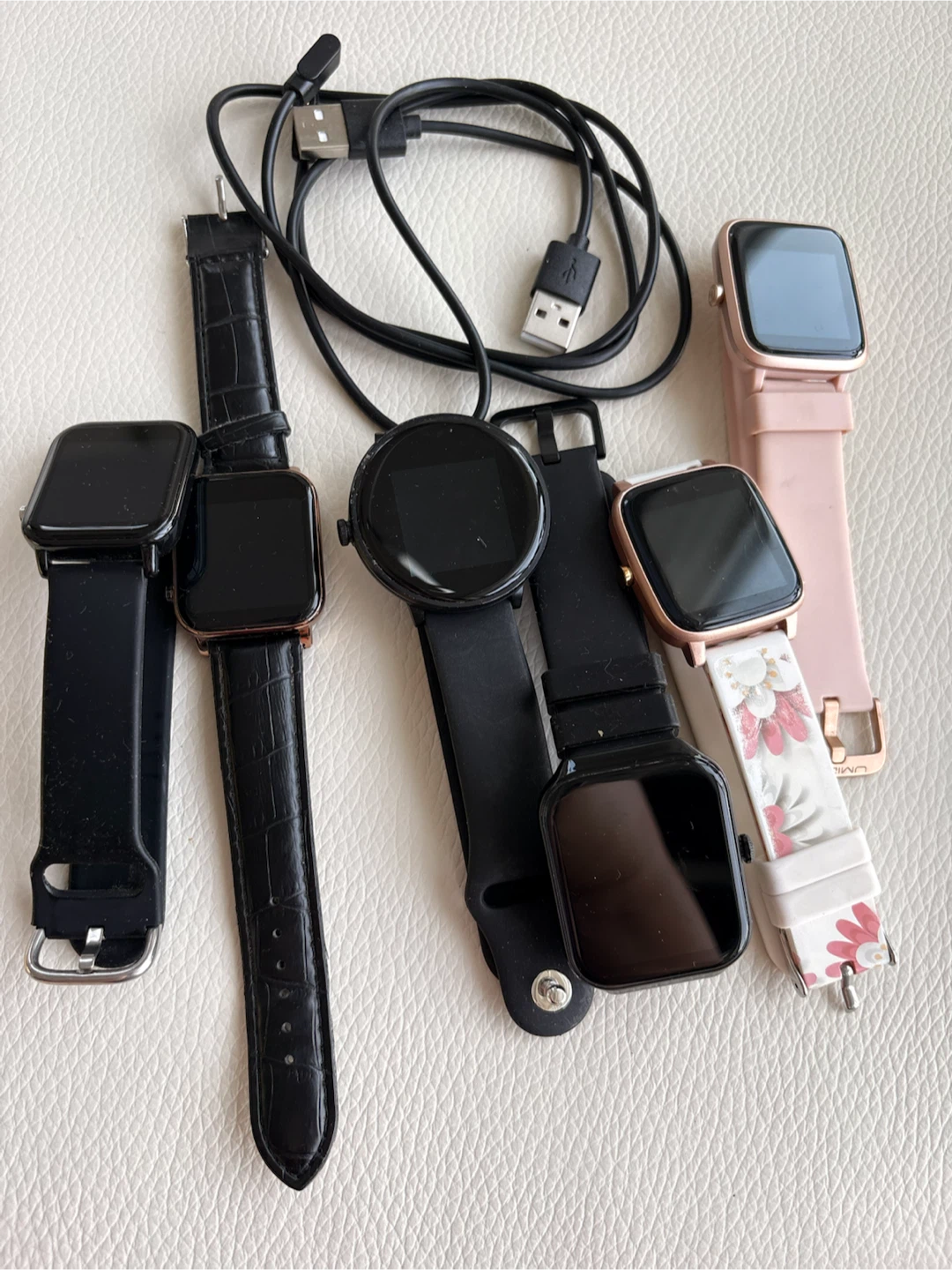 Assorted Smartwatches and Charging Cable