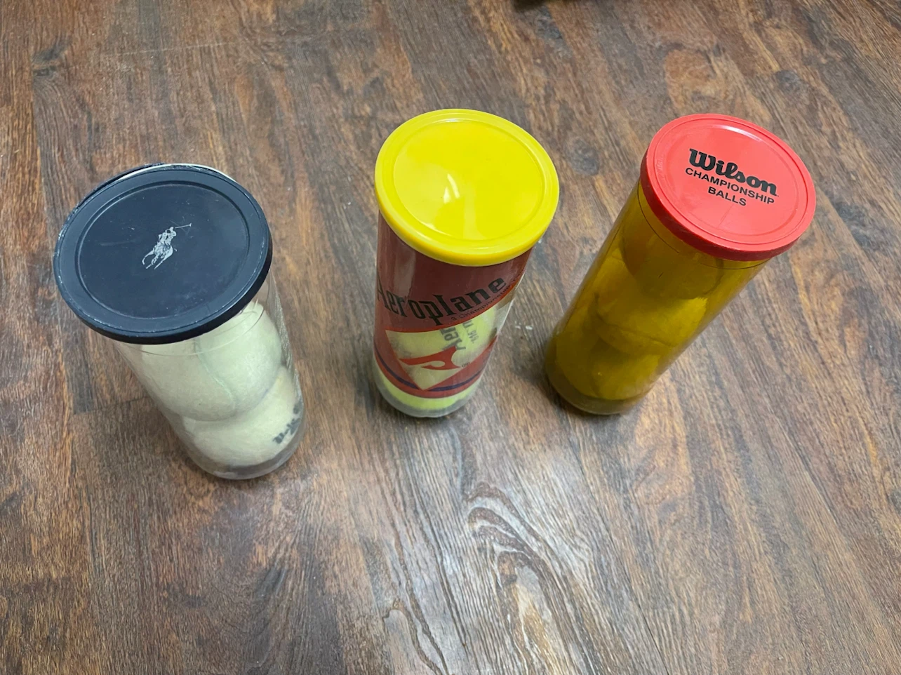 Assorted Tennis Balls in Containers