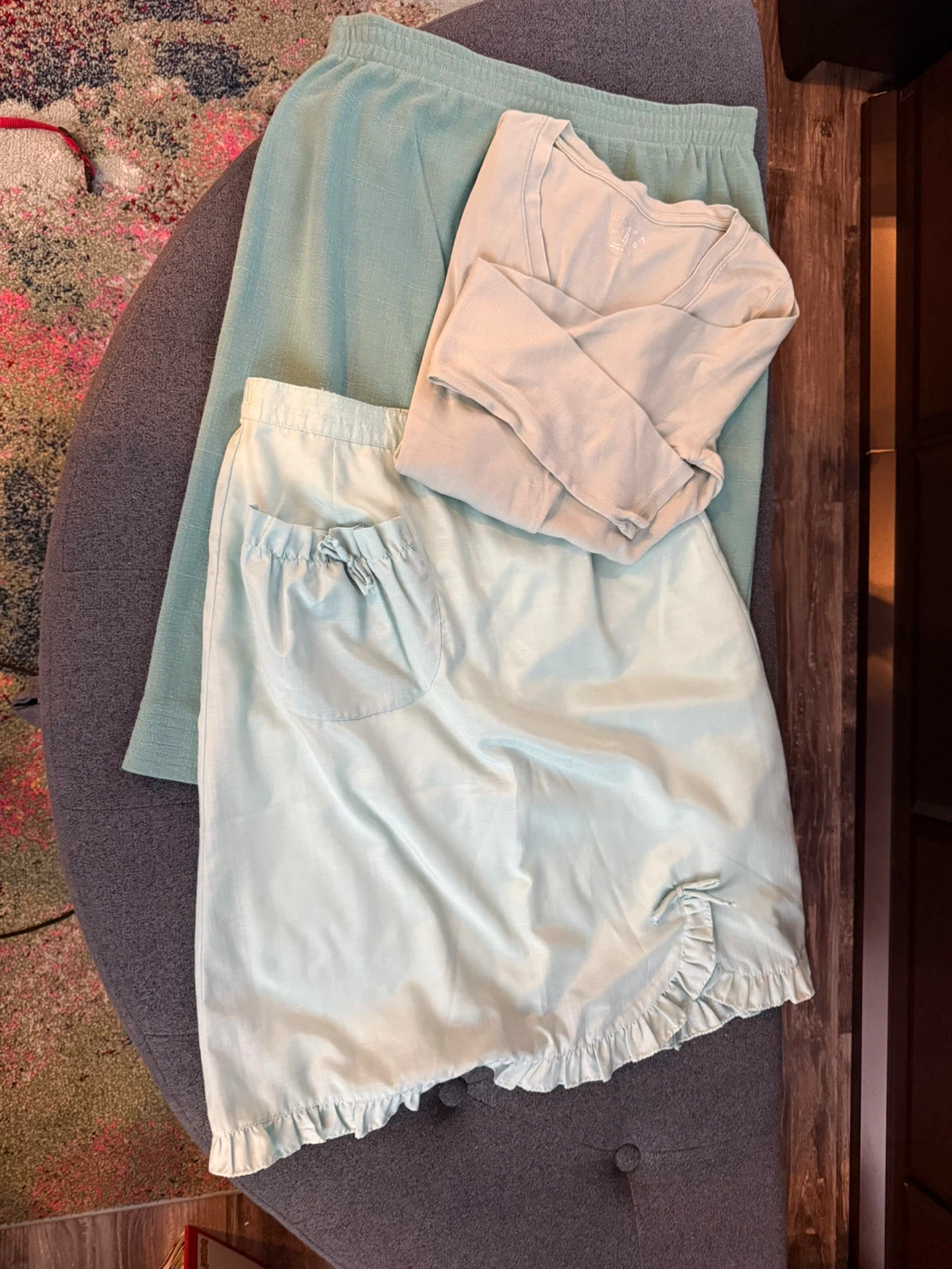 Two light blue skirts and one long sleeve top