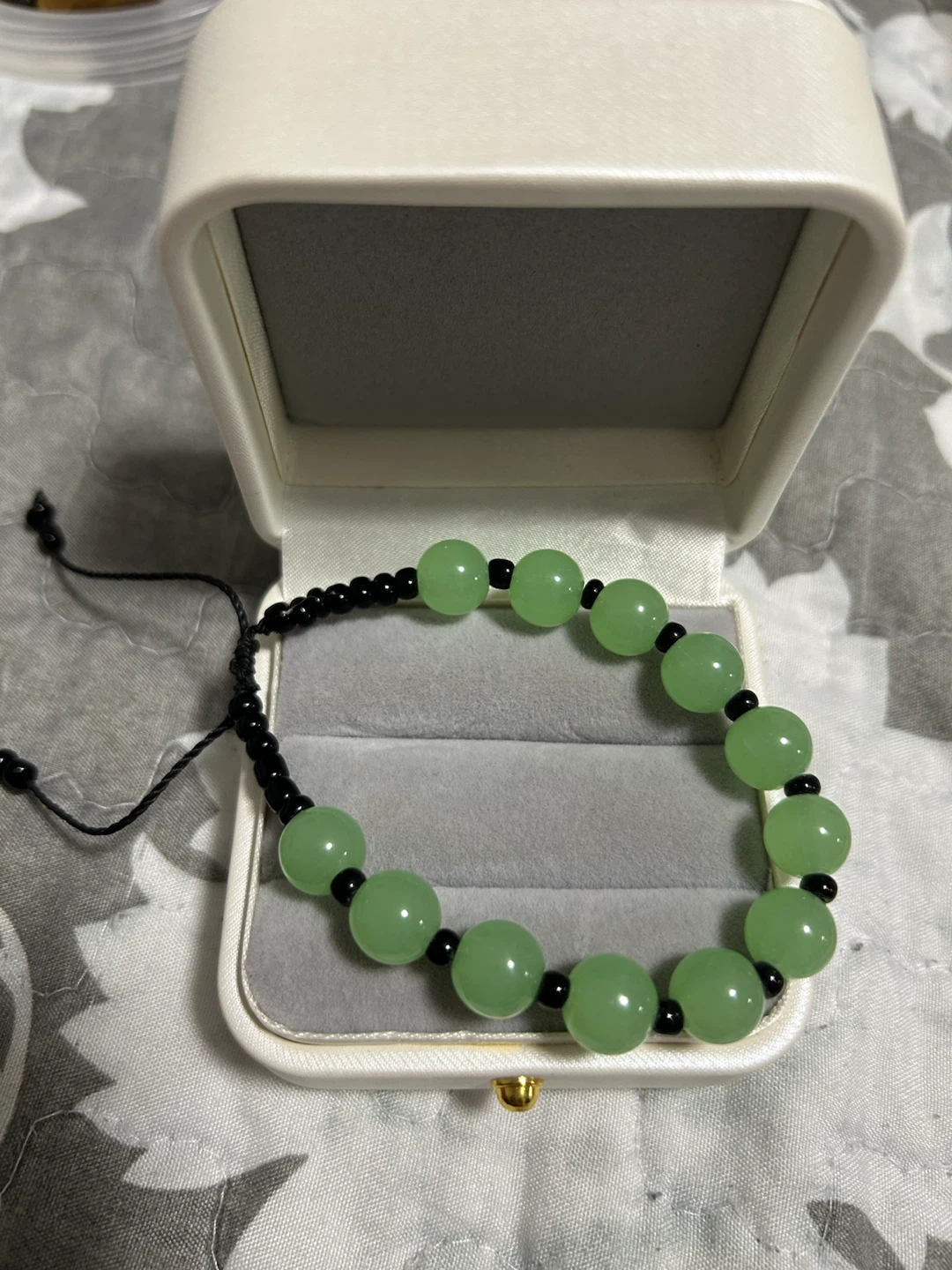 Green bead bracelet with adjustable black cord