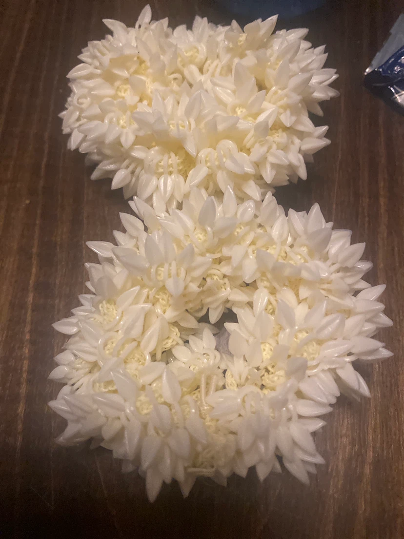 Two cream-coloured floral hair scrunchies