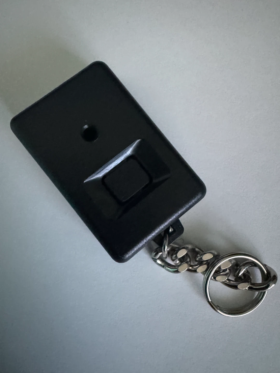 Black plastic keychain case with metal ring