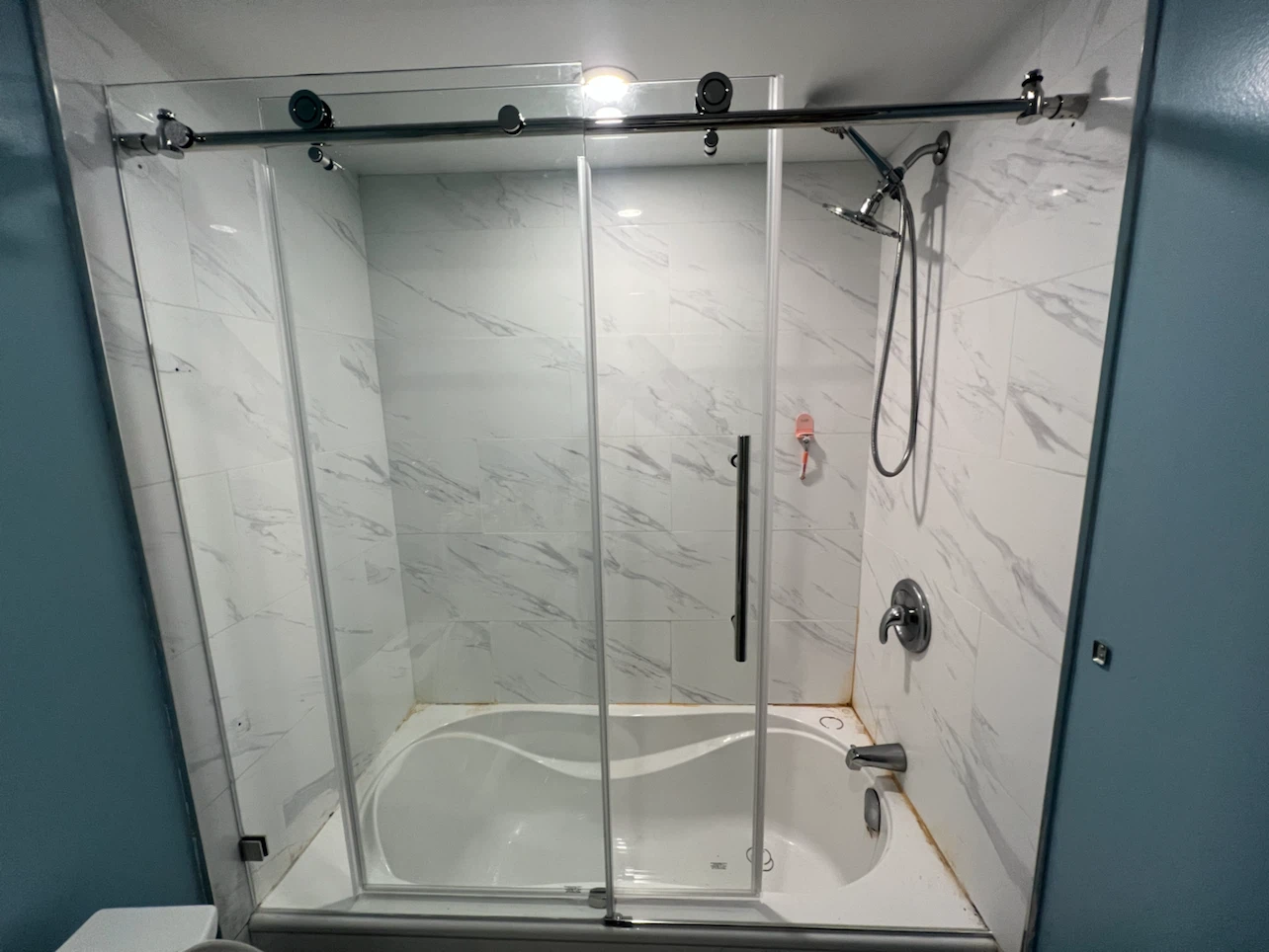 Sliding glass shower door installation
