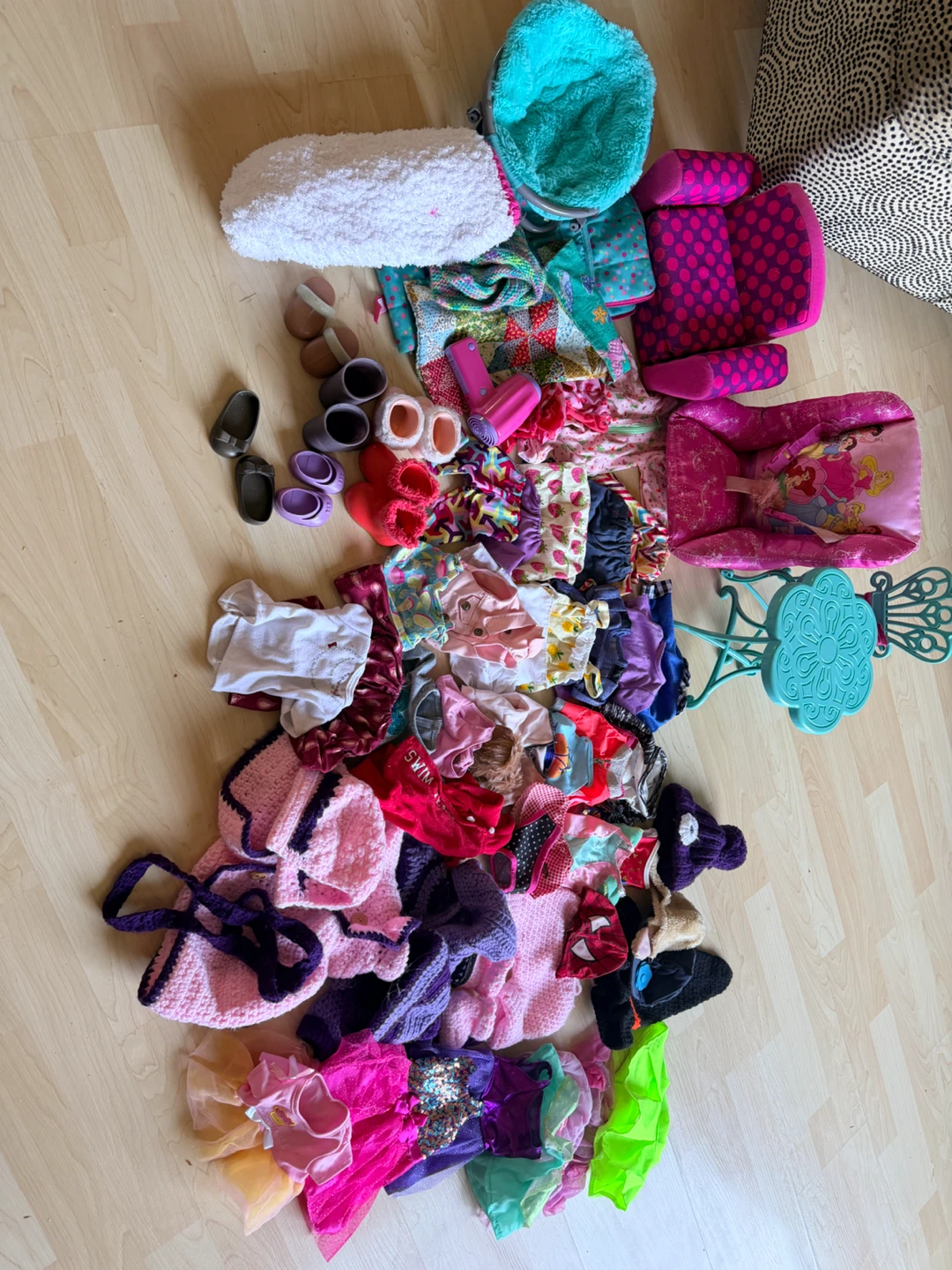 Variety of doll clothes and some furniture