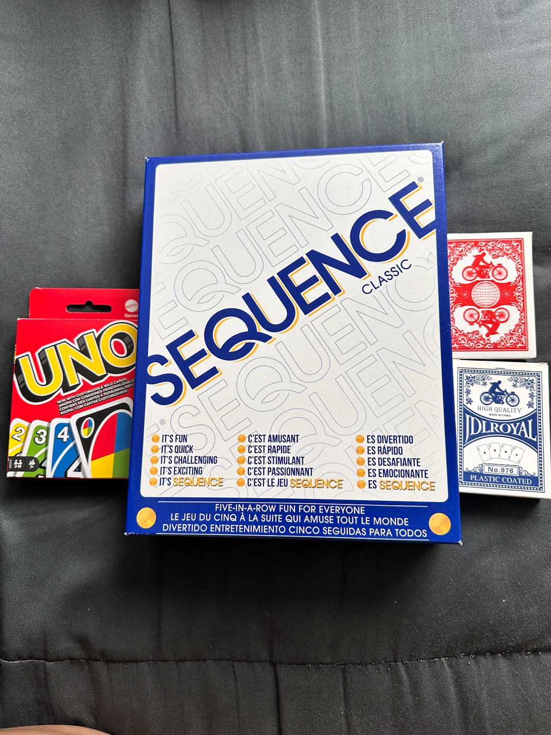 Sequence board game, card packs, and Uno cards