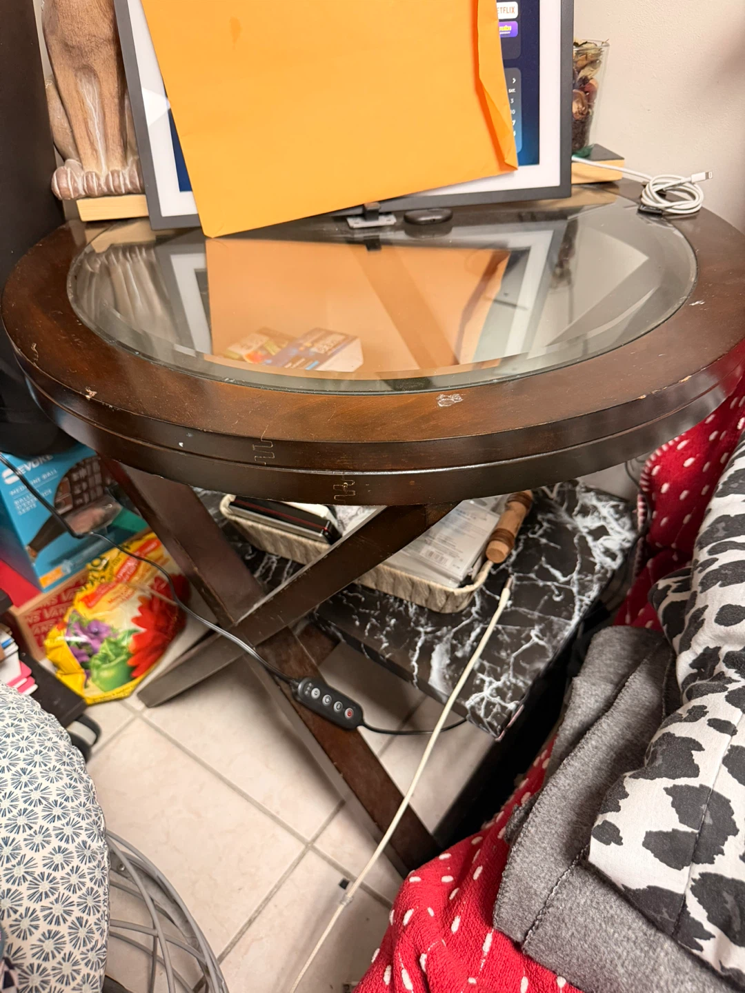 Round wooden side table with glass top