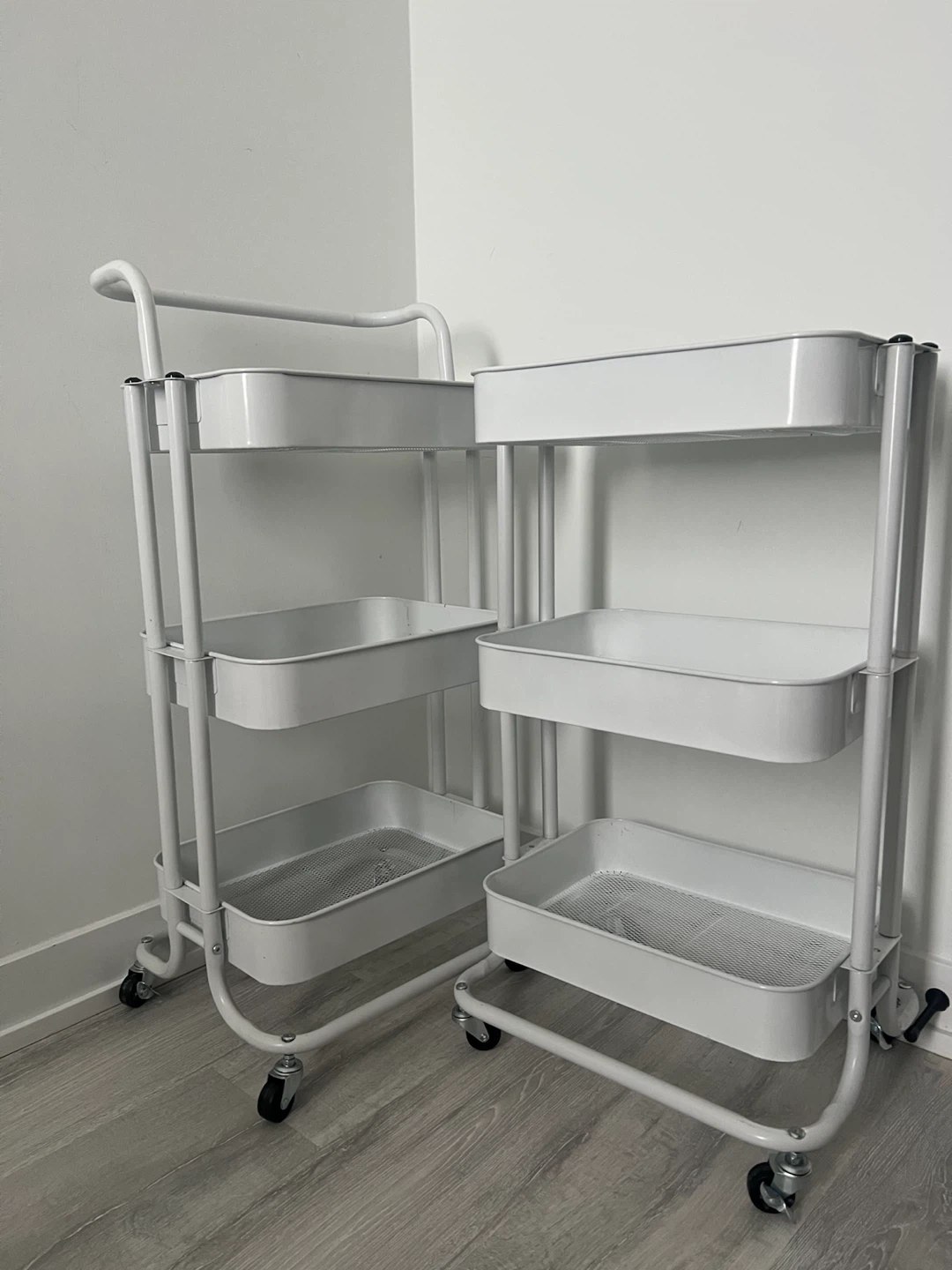 Two White Rolling Utility Carts