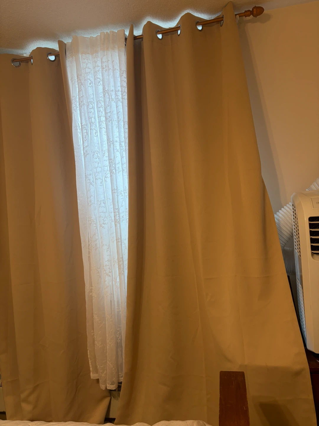 Beige grommet curtains and white lace sheer panels