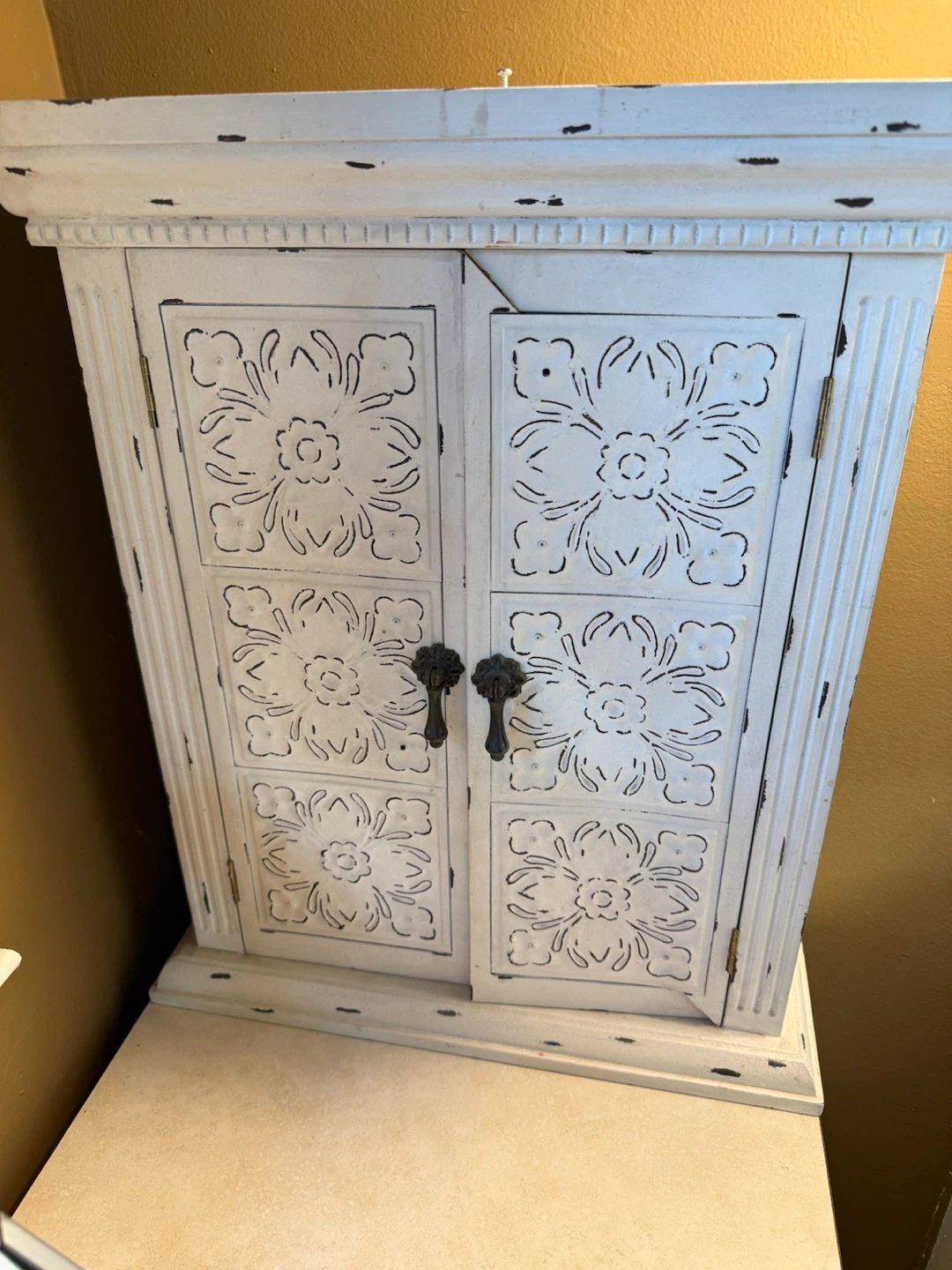 Distressed White Wall Cabinet with Floral Pattern Doors