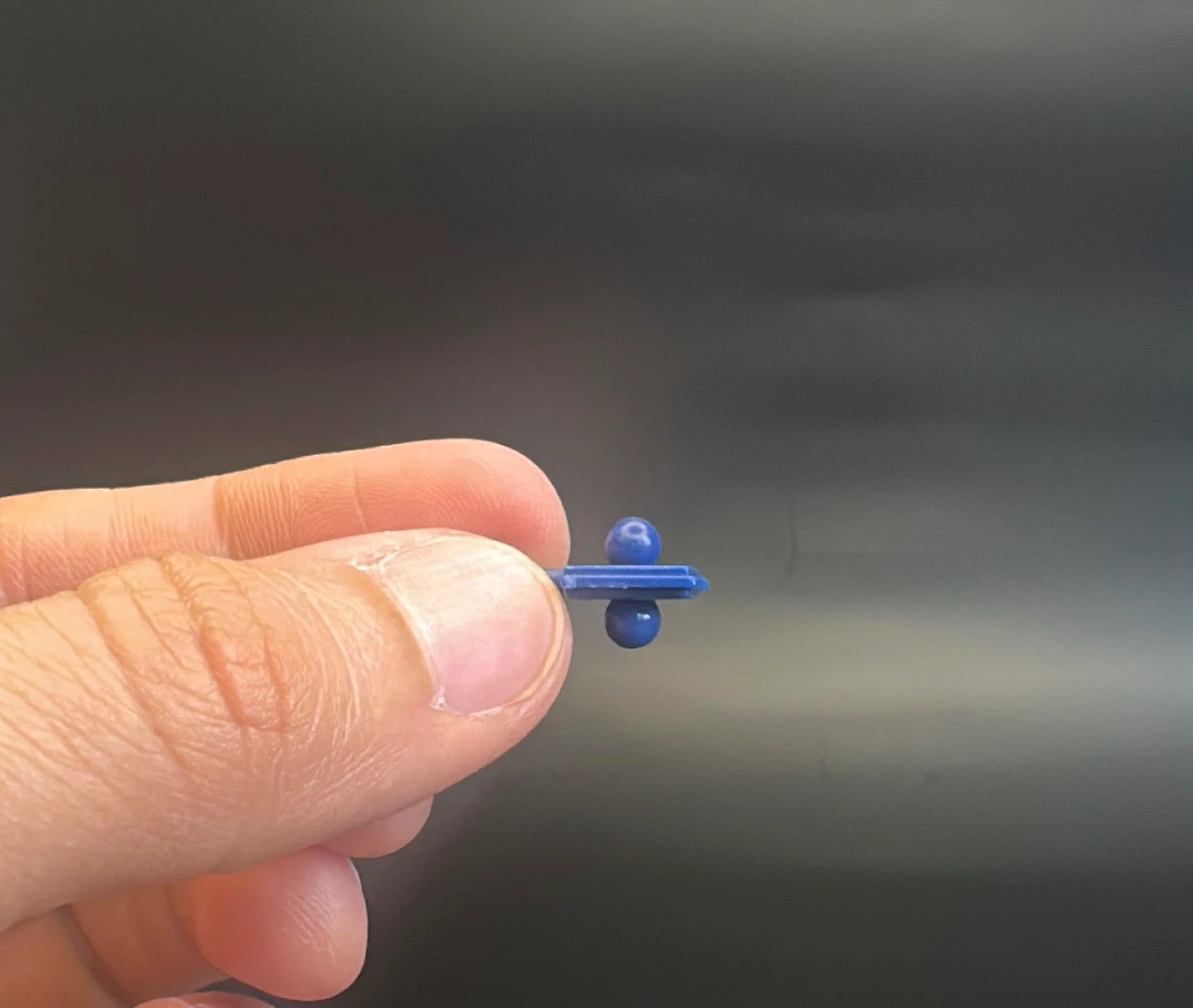 Blue plastic toy connector piece