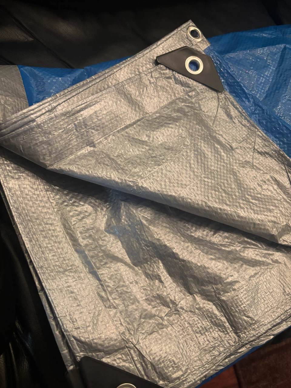 Two Blue and Silver Utility Tarps