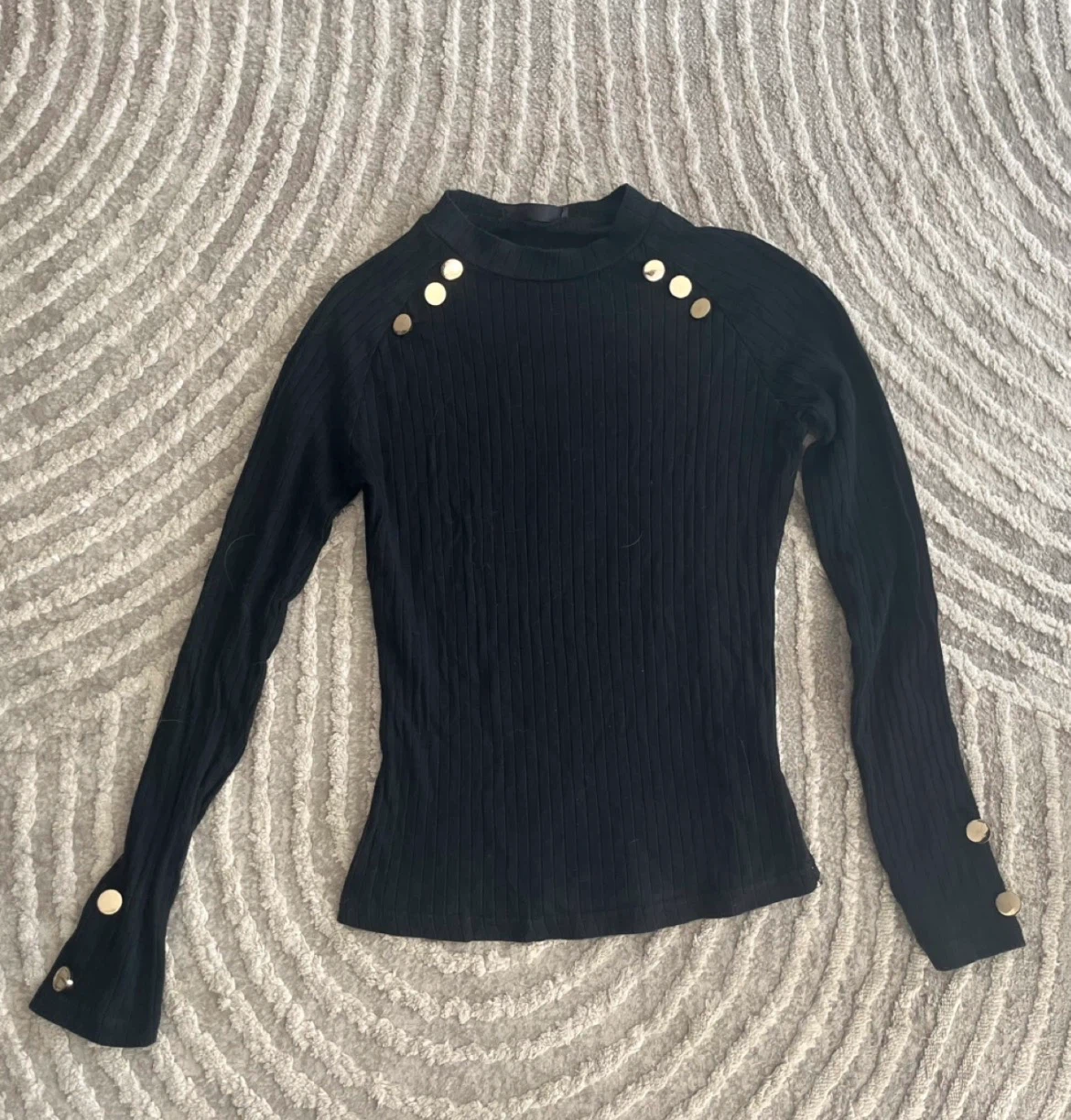 Black ribbed mock neck long sleeve top with gold buttons