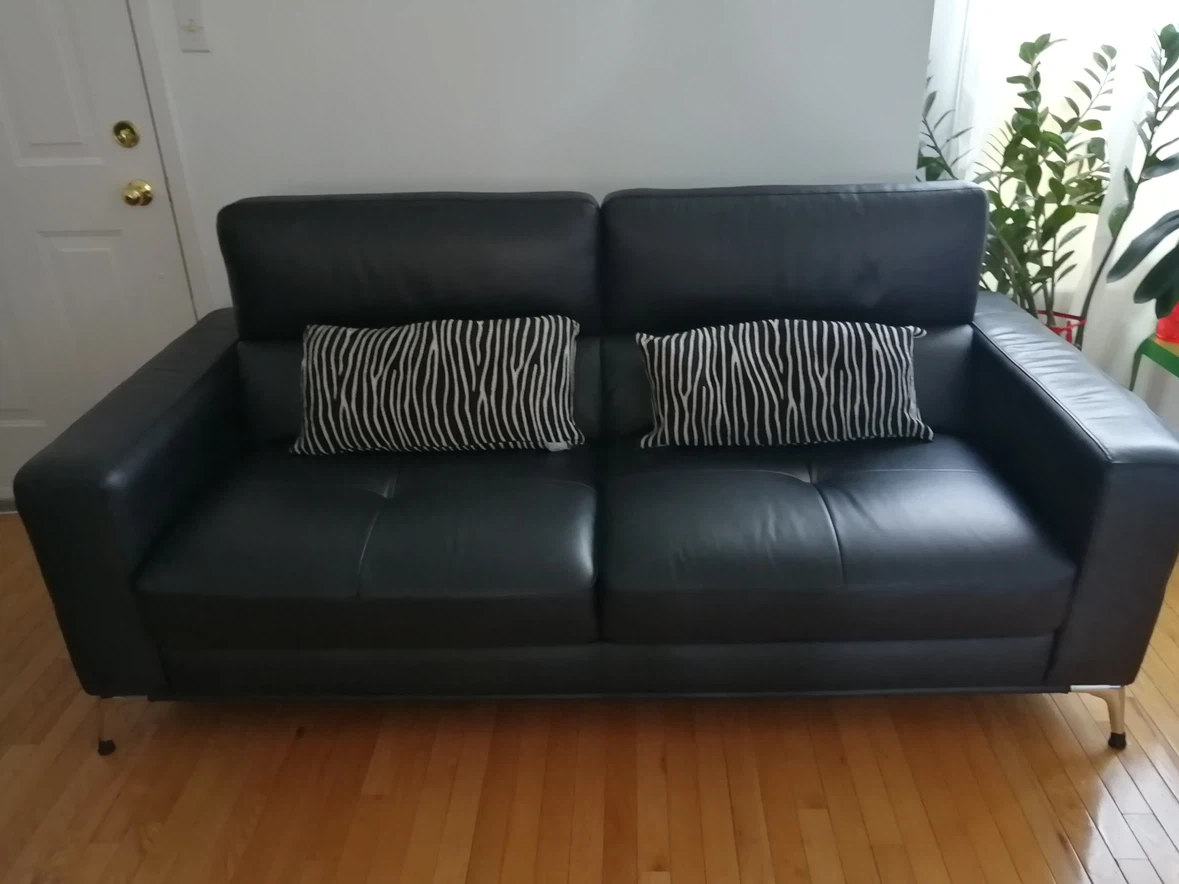 Black leather two-seater sofa