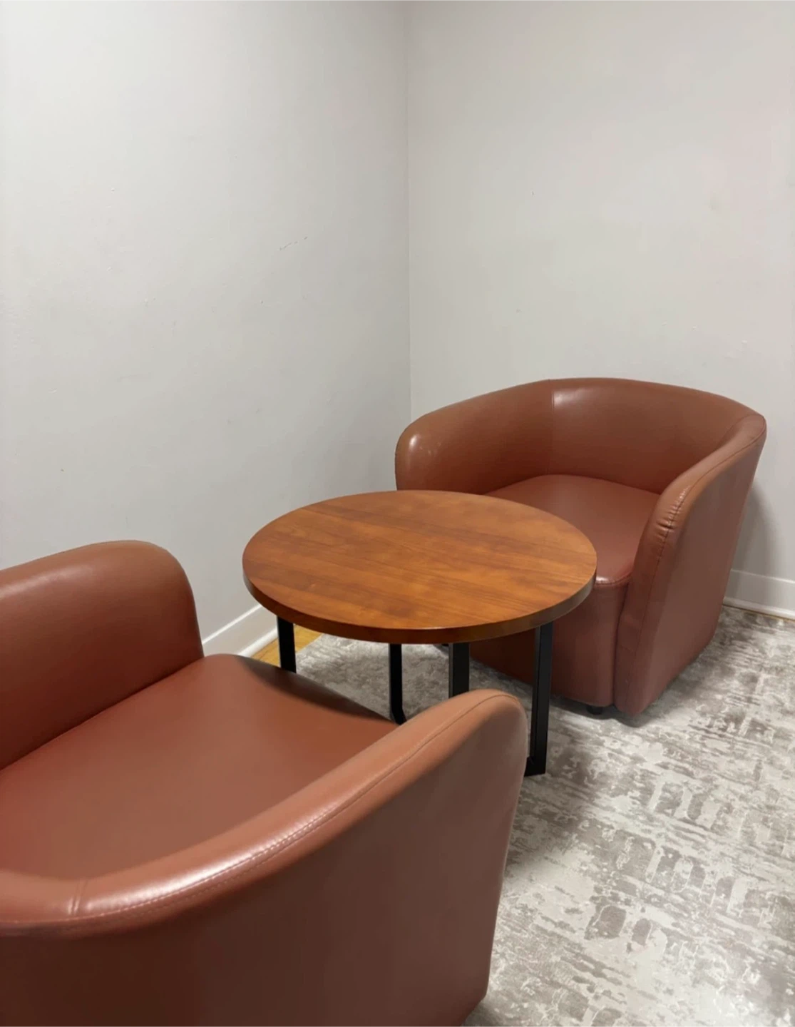 Two Brown Faux Leather Club Chairs