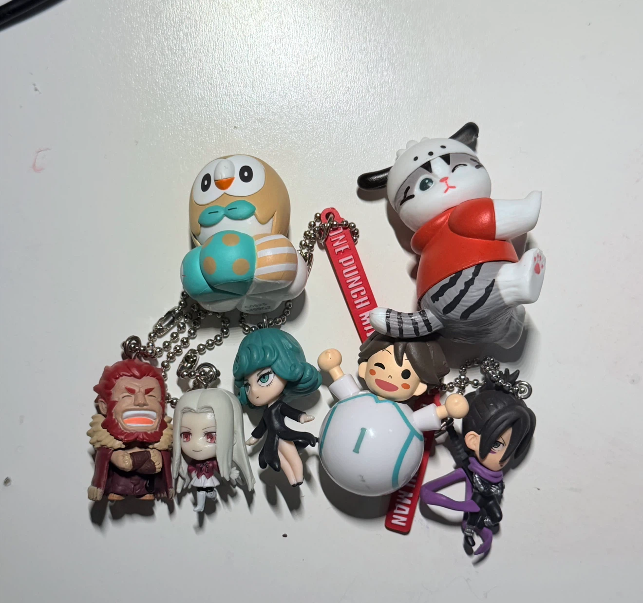 various gachapon figures and keychains