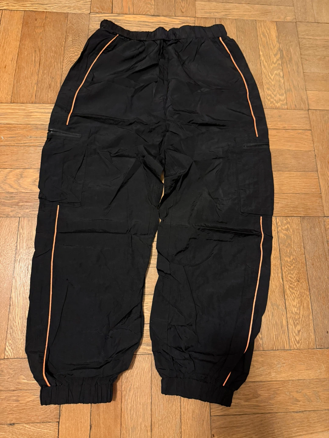 black cargo pants with orange trim