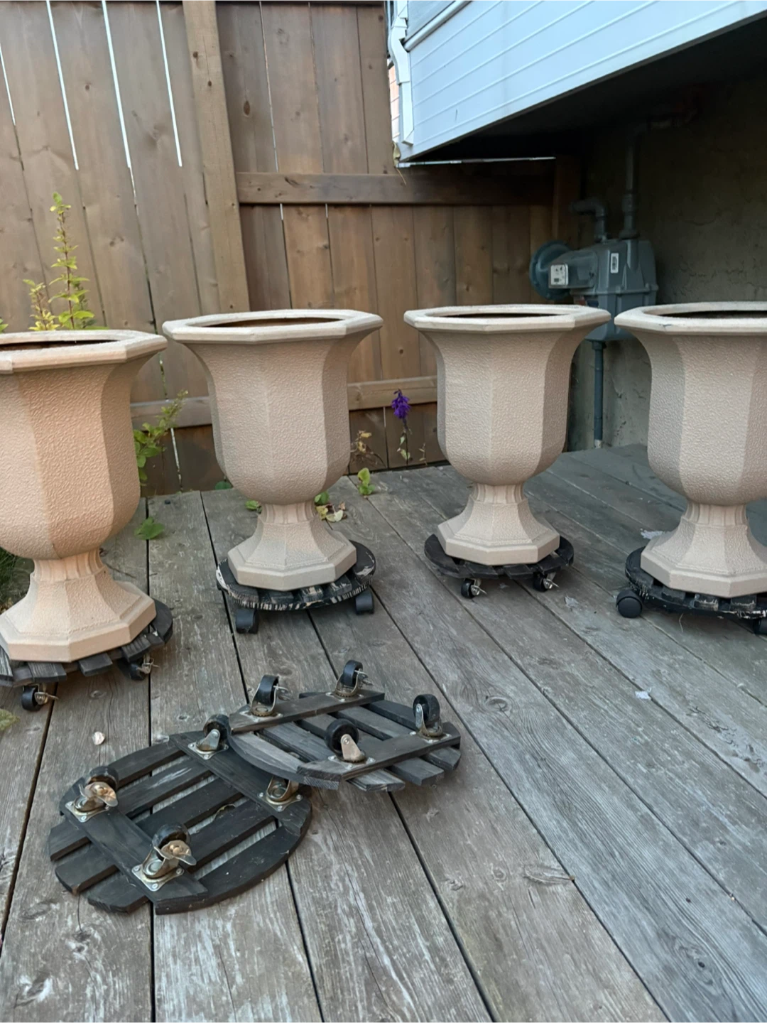 Set of 4 Urn Planters with Wooden plastic Dollies$75